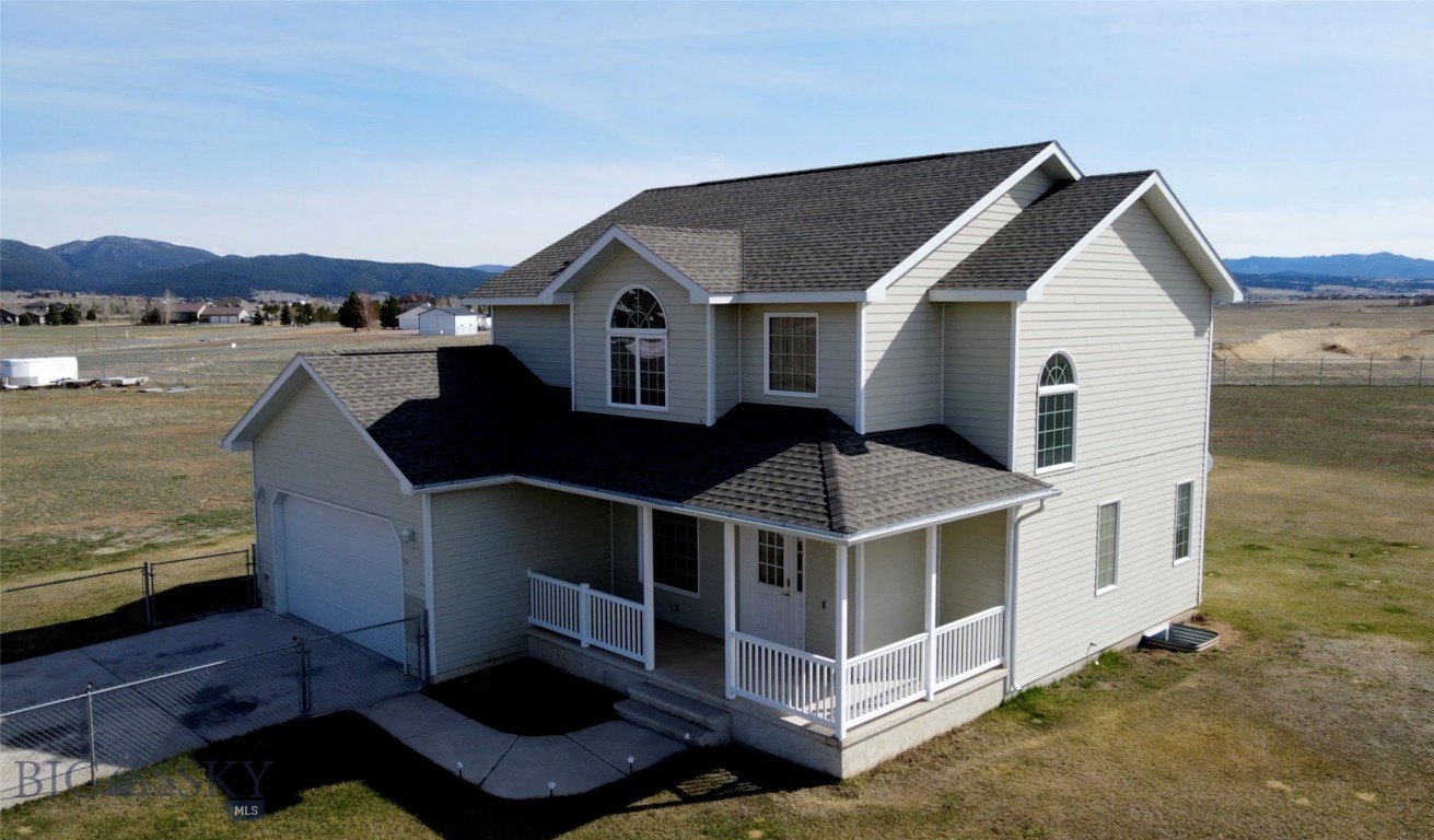 Nestled on 2.5+ acres in south Butte, this property offers the perfect balance of peaceful, semi-country living with the convenience of being just minutes to town. Enjoy access with paved roads most of the way. This spacious home features four bedrooms and two and a half bathrooms. The main floor includes a welcoming living room, dining room, kitchen and a convenient half bath. Upstairs, you will find four bedrooms, including a generous master suite, along with two full bathrooms. The full basement is currently unfinished, offering a great opportunity to create additional living space to suit your needs. The fully perimeter-fenced 2.5-acre property provides ample space to accommodate your motorhome, extra vehicles, trailers, and all your favorite outdoor toys. Whether for storage or recreation, you'll have plenty of room to make the most of your land. Additionally, the property is conveniently serviced by natural gas, ensuring reliable energy for your home. Newer roof. (Property is agent owned. Some pictures are virtually staged to help buyers see the potential of the space, these pictures are watermarked "Virtually Staged").