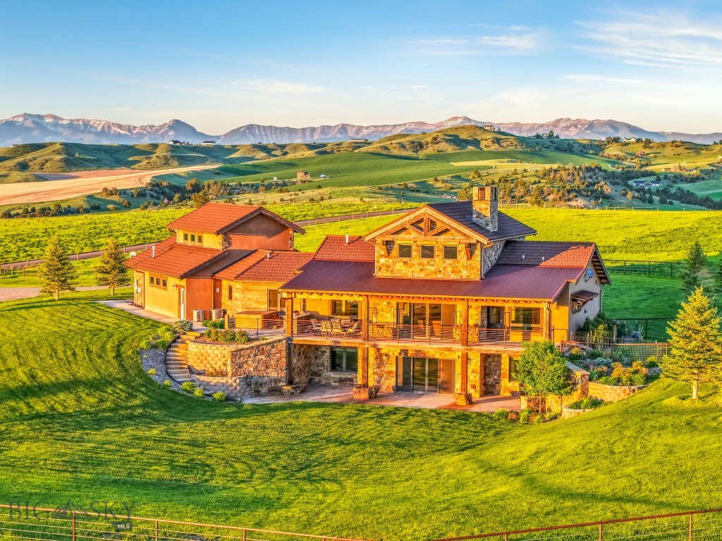 Set on 20 acres of gently rolling land, this 4,682 sq. ft. custom-built estate offers a rare blend of luxury, comfort, and functionality in a truly breathtaking setting. Surrounded by uninterrupted views in every direction, this property embodies the essence of refined country living.
Step inside to a grand living area featuring striking stonework, a soaring fireplace, and expansive sliding glass doors that frame the sweeping landscape and open to a spacious covered deck—perfect for outdoor dining and relaxation.
The gourmet kitchen is designed for both style and performance, boasting premium Thermador appliances—including double wall ovens, a paneled refrigerator, 6-burner cooktop with griddle, and Bosch raised dishwasher—alongside a generous island, extensive counter space, and a large walk-in pantry.
The main-floor primary suite offers a tranquil retreat with spa-like amenities, including a copper soaking tub, dual vanities, and an in-closet washer and dryer. Completing the main level are a mudroom with sink and storage, a three-quarter bath, and a versatile bonus room above the three-car garage that can serve as a fourth bedroom, studio, or office.
The daylight basement extends the home’s living and entertaining space with large view windows, a family room with wet bar, access to a covered patio, two bedrooms, two full baths, a laundry room, and a flexible area ideal for a home theater, gym, or recreation zone.
Designed with equestrian enthusiasts in mind, the property features a large barn with a 2-bedroom, 1-bath apartment—ideal for guests, caretakers, or rental income. The smooth wire electrical perimeter fencing, corrals, and open pastures make this an ideal setup for horses or livestock.
From its rolling topography to its high-end finishes, this remarkable property delivers the ultimate blend of sophistication and rural beauty.
Experience the freedom and serenity of estate living—schedule your private tour today!