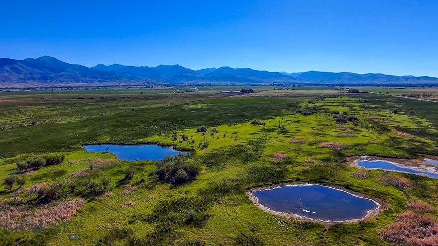 Located in the heart of Big Sky country, 7 Springs Ranch sits between Twin Bridges and Sheridan, Montana, in the famed Ruby River Valley, known for its breathtaking scenic beauty, four blue-ribbon rivers, and five surrounding mountain ranges. Several spring-fed ponds support a substantial population of white-tailed deer, as well as good numbers of waterfowl and pheasants. There are no existing structures on the ranch, providing a blank canvas for a new owner. Dramatic build sites overlook the lower riparian area. This property is perfect for outdoor enthusiasts and boasts several characteristics that are in high demand and low supply in the recreational ranch market. Easy access is a huge plus, just an hour and a half from Bozeman and its commercial airport. Surrounded by gorgeous mountain ranges, there is no end to recreational opportunities in this valley. Come see for yourself!