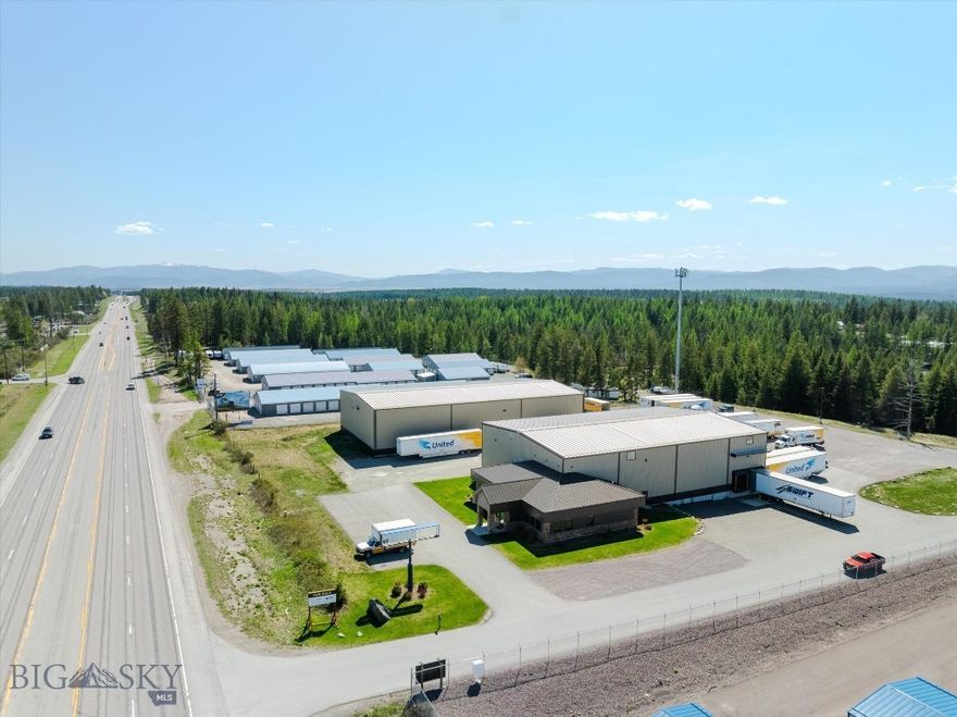 Located on U.S. Highway 93 S, just two miles from Whitefish and four miles from Kalispell, this 3.9-acre commercial property features two Nucor pre-engineered metal buildings constructed in 2016. The site includes a large, secure yard designed for 53' truck movement and equipment storage, with additional room for future development. Building 1 spans 12,000 SF, comprising 10,000 SF of warehouse space with 30' ceilings, four dock-high doors, two grade-level doors, a mezzanine, and a restroom. It also includes 2,000 SF of finished office space with a reception area, four private offices, a breakroom, and two bathrooms. Building 2 is an 12,000 SF warehouse with 30' ceilings and three grade-level roll-up doors. Both buildings feature security systems, heavy power, natural gas, a private well, and a septic system. With 303 feet of Highway 93 frontage, a 26,386 AADT traffic count, excellent signage, and direct highway access, the property is just 7.5 miles from Glacier Park International Airport (FCA), offering prime visibility and versatility for warehousing, equipment sales, retail, or other commercial uses.