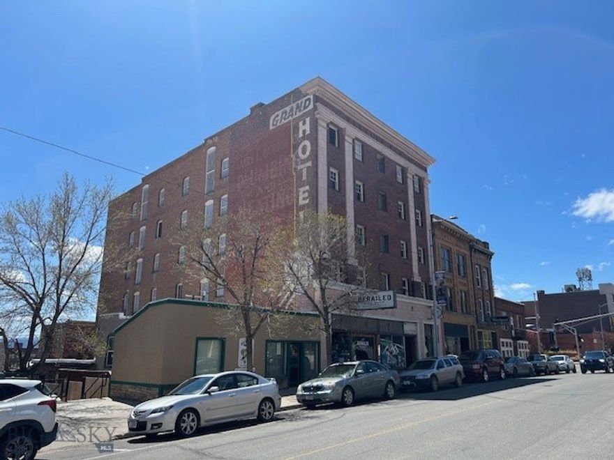 This historic Butte landmark, The Grand, offers a unique opportunity for visionary investors. Built between 1915-1916 as a robust labor temple, its unconventional 2-foot-thick brick exterior speaks to its enduring strength. After a storied past as a hotel, housing Golden Glove boxers under Senator Burton K. Wheeler's direction, The Grand was acquired by the Bolter family and later Bob Lequere, who established a high-altitude boxing training center.

The building boasts significant modern upgrades. The basement, home to the Quarry Brewery, was fully renovated in 2011 with updated electrical and in-floor heating, and holds a long-term lease. The first floor, updated in 2013 with new electrical and plumbing, features a leased space for Derailed Bike Shop (seeking a long-term lease), a private party room, and two offices with an inviting lobby. This floor's unique 2x8 edge-set timber deck provides robust support.

The upper four floors (2-5), each spanning 4,986 square feet, are a developer's dream. Currently with original lath and plaster construction, they are primed for conversion into 20 apartments or condos (five per floor), with a proposed mix of two-bedroom/two-bath, two-bedroom/one-bath, and studio units. Floors 3 and 5 offer exceptional flexibility, with the 3rd floor capable of being cleared for an open layout, and the 5th floor providing stunning 360-degree mountain views. Plumbing and electrical stubs are already in place, ensuring a smooth development process for the upper floors.