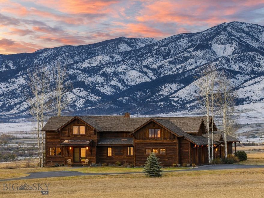 Positioned on 12 scenic acres and surrounded by neighborhood open space, this exceptional Montana property captures sweeping 360-degree views of the Bridger Mountains and and surrounding ranges, farmland, and the wide-open landscape that truly defines the region. Designed by Brechbuhler Architects and masterfully built by Teton Heritage Builders, this custom home was thoughtfully crafted to embrace its remarkable setting, offering a seamless balance of refined comfort, exceptional craftsmanship, and connection to the outdoors. Inside, expansive windows frame the surrounding vistas while warm natural materials and vaulted ceilings create an inviting mountain-modern atmosphere. The main living spaces are designed for both quiet retreat and effortless gathering, anchored by a striking floor-to-ceiling stone fireplace and flowing naturally into the kitchen and dining areas, perfect for hosting family and friends after a day spent exploring the outdoors. The main-level primary suite offers a private sanctuary with its own fireplace and spa-inspired bathroom, while additional guest spaces and flexible living areas provide comfort and privacy for visitors, as well as multiple options for a work-from-home lifestyle. The lower level is designed with entertaining in mind, featuring a generous lounge space, a fireplace, a wet bar, and a temperature-controlled wine room, ideal for relaxed evenings and memorable gatherings. Outdoor living is equally inviting, with a spacious patio, built-in grilling area, hot tub, and wood-burning fire pit set against the backdrop of Montana’s expansive skies. The property also includes a storage shed and ample room for future enhancements, including planned space for a barn/guest house, perfect for those seeking a true Montana lifestyle. Surrounded by open space yet just a short drive to Downtown Bozeman, the Bozeman Yellowstone International Airport, and year-round recreation, this property offers a rare blend of privacy, views, and timeless Montana living.