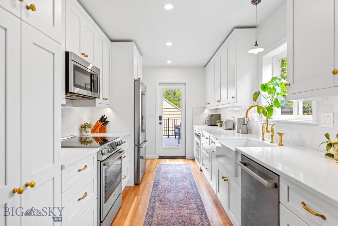 Ideally located just one block from an elementary school and a short stroll to downtown Livingston, 215 South 10th Street is a rare Southside offering that seamlessly blends timeless character with thoughtful modern upgrades. This beautifully appointed 6-bedroom, 2-bathroom residence spans three levels, with existing plumbing in place for a third bathroom—providing both immediate comfort and future flexibility.
At the heart of the home, a recently renovated kitchen exudes quiet luxury with curated finishes including a deVOL brass faucet and lighting fixtures, unlacquered brass cabinet hardware, and upgraded Bosch appliances—all selected for their craftsmanship and enduring appeal. The main floor features a spacious primary suite for convenience and privacy, as well as a dedicated home office—perfect for remote work or creative pursuits. Upstairs, three sunlit bedrooms showcase the home’s original architectural charm.
The expansive basement provides generous space for a home gym, studio, guest quarters, or additional storage. Outdoors, enjoy a spacious backyard ideal for entertaining or gardening, a newly built deck, and a detached two-car garage with alley access—offering exciting ADU potential.