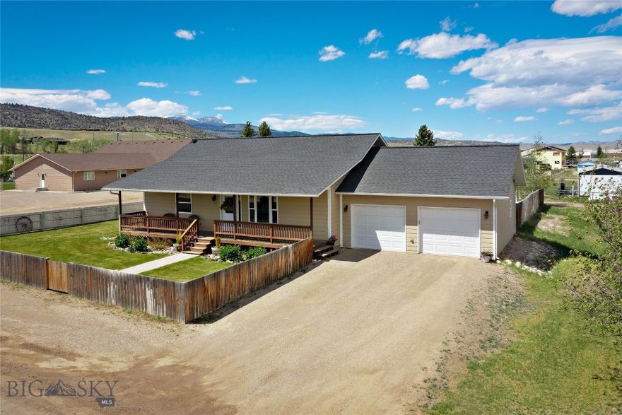 Great In-Town Ennis Home with 5 Bedrooms & Room to Entertain!
Enjoy Madison Range views from the deck of this immaculate, spacious, and well-maintained Ennis home, conveniently located close to downtown, schools, shopping, the park, and the Madison River. Situated on a landscaped .34± acre lot with privacy fencing, this move-in ready property offers plenty of room for family, guests, and entertaining.
The 2,560± sq ft home features an open floor plan with vaulted ceilings and abundant natural light throughout the kitchen, dining, and living areas. The kitchen includes stainless steel appliances, ample counter space, and an island with an eating bar. The dining area opens to the patio, creating a great space for BBQs and outdoor entertaining.
The main level includes 3 bedrooms, including a primary suite with a walk-in closet and private bath, along with an additional full bathroom. Downstairs offer a family room, 2 additional bedrooms, and another full bathroom, providing space for guests.
An attached oversized 2-car garage provides excellent storage for vehicles and outdoor gear. 
The landscaped front yard features underground sprinklers, while the huge fenced backyard offers privacy and room to enjoy Montana living in the heart of Ennis. Walking distance to  school, 4 churches and one block to the Post Office.
