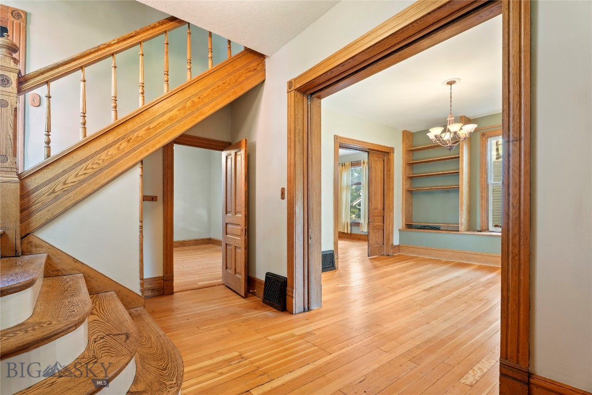 Discover the charm and elegance of a bygone era in this enchanting Victorian home, ideally situated on historic 6th Avenue, just moments from the Capitol building. This four-bedroom, two-bathroom residence offers a unique blend of classic architectural details and updated comforts.
As you enter the home you're greeted by the double-sided, open staircase, with sweeping ceilings. Step inside to find a grand parlor and a separate, inviting living room with multiple sets of pocket doors, perfect for entertaining or quiet relaxation. The gas fireplace encased in its traditional mantel and tile offers warmth and ambiance. The home's character shines through in its preserved woodwork and period features. The kitchen has plenty of hickory cabinets and an island for additional prep space. Enjoy a cup of coffee on the sun-drenched, glass-enclosed porch. Main floor laundry is handy, and the back porch can hold your "get-going-and-out-the-door" gear!
The practical layout includes four generously sized bedrooms with 10ft ceilings, offering ample space for family and guests, while two bathrooms ensure convenience. The primary bedroom has an adjacent room that has been skillfully converted into a walk-in closet, which could also be an office. The upstairs bathroom has a claw-foot tub and penny tile. You'll appreciate the convenience of the main floor bathroom, as well. Outside, the property boasts a private, fenced yard, creating a secure and serene outdoor space. A detached garage provides valuable off-street parking and additional storage. The basement holds the home's gas, forced-air furnace and hot water heater, with easy access and plenty of room for storage.
This home presents a rare opportunity to own a piece of local history in a prime, walkable location. Experience the best of both worlds: the timeless beauty of Victorian architecture with the convenience of a modern lifestyle.