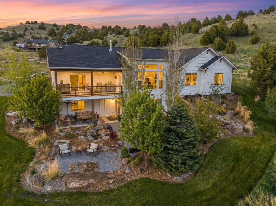 Breathtaking Views, Elevated Comfort, and True Montana Living - Just 15 Minutes from The Madison and Bozeman Welcome to 388 Pacer Landing - where country tranquility meets upscale comfort on nearly 9 acres of hillside paradise just off Norris Road. Nestled in the scenic Manhattan countryside, this stunning 5-bedroom, 2.75-bath custom home offers sweeping Tobacco Root Mountain views, vibrant outdoor living spaces, and the kind of thoughtful design that makes everyday life feel like a retreat. Inside, the home stuns with vaulted ceilings, oversized windows, and an open-concept main floor that brings light, space, and views into every room. Entertain effortlessly from the kitchen to the inviting living and dining areas - all flowing seamlessly together for gatherings large or small. The primary suite features a private ensuite bath and walk-in closet, while two additional bedrooms and a full bath offer more main-level dwelling. The walkout daylight basement expands your options with a large second living area/movie room, two more bedrooms (one converted into a home gym), a third bathroom, and generous storage space. Head outside to three covered outdoor living areas including a covered front porch, upper-level deck, and lower patio, all surrounded by mature trees and curated landscaping for privacy and comfort. A firepit patio faces west toward sunset views, while a landscaped creek and pond create a peaceful focal point for outdoor relaxation. The yard is supported by a full irrigation system with sprinklers and drip lines, multiple boulder retaining walls, and colorful landscape beds. Juniper trees and wandering wildlife bring the land to life, creating a peaceful connection to nature. Additional features include: Hot tub with views, insulated 30x40 shop with wood stove and 12' ceilings, laundry/mudroom off the 2-car garage, room for animals, gardening, or expansion, and peaceful country roads ideal for walking and connecting with neighbors. Whether you're looking to raise a few animals, host unforgettable gatherings, or simply live immersed in Montana beauty while staying close to Bozeman, 388 Pacer Landing offers it all.

Be sure to watch the video and immerse yourself in this property from sun up to sun down.