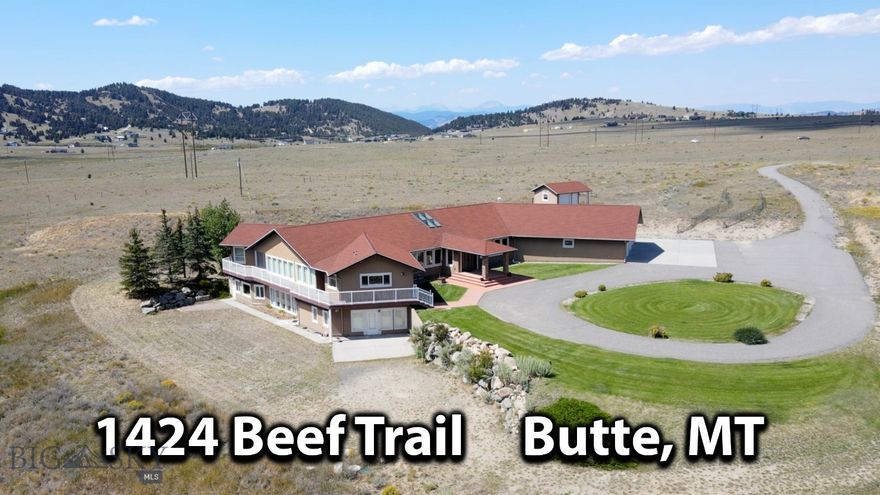 Presenting a Montana masterpiece that is tucked away on 65 acres and is surrounded by The Rocky Mountains.  It offers a perfect mix of having "plenty of elbow room" but still being only minutes to town (Butte) on maintained roads.  As you approach this unique property, a sense of anticipation fills the air knowing you are about to enter a realm of enchantment—a place where privacy reigns supreme and breathtaking vistas unfold before your eyes.  A grand foyer welcomes you into a luxurious and elegant house with architectural features and ornamentation that make this estate extra-special. Step into any room and you will be greeted by spectacular panoramic views of the majestic mountain ranges.  The heart of the home holds a walk-in atrium that exudes soothing energy tranquility.  Multiple primary suites, each with its own walk-in closet, provide comfort and privacy.  The basement is a walk-out and an elevator is available to get you from floor to floor. The wrap around deck allows a seamless transition from the indoor to outdoor the spaces.  3-car attached garage.  For those who cherish the equestrian lifestyle, a charming horse barn and corral await.   Southwest Montana is rich in recreation, wildlife and scenery and this magnificent property was built for comfort, privacy, and total enjoyment of life!