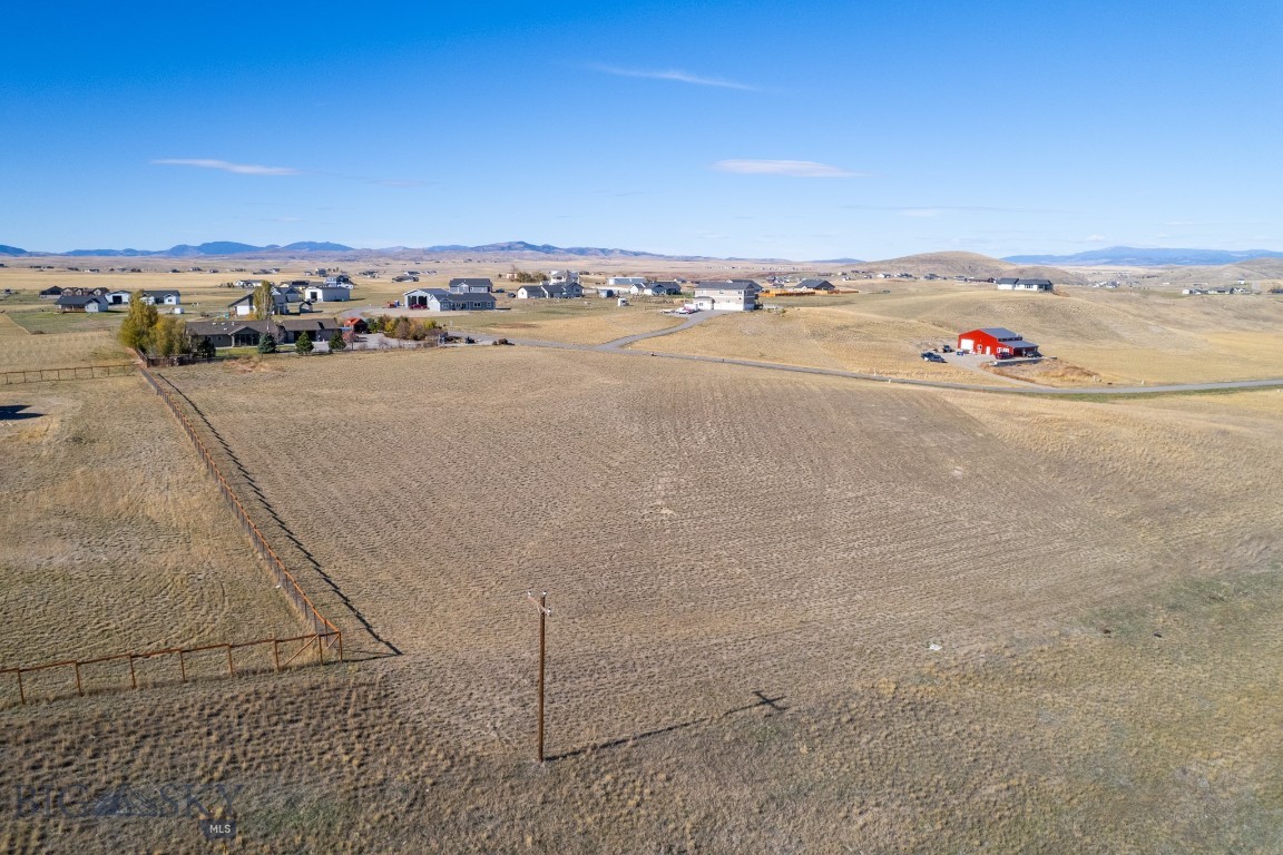 Settle into quiet country living with this elevated parcel in the desirable Wheatland Meadows subdivision. Spanning over 3 acres, this gently sloping lot is perfect for a custom home, offering expansive, unobstructed views of the Spanish Peaks, Bridger Mountains, Gallatin Range, and Horseshoe Hills. This peaceful location features paved roads, nearby parks, and utilities with power ready at the lot. The covenants allow for building 2 accessory buildings, including a shop, making it an ideal choice for those with tools, toys, or hobbies. Outdoor enthusiasts will be thrilled with the proximity to Copper City Bike/Walking/Horse Trails, Headwaters State Park (where the Missouri River is formed from the Madison, Jefferson and Gallatin Rivers), Lewis & Clark Caverns and the local golf course. Enjoy world-class blue-ribbon fishing, hunting, and endless recreational opportunities nearby. For those lake anglers, Canyon Ferry Reservoir is just 35 minutes away. This property is just 30 minutes from Bozeman Yellowstone Airport and centrally located with easy access to Bozeman, Butte, and Helena. Don’t miss this chance to create your dream retreat in Montana’s beautiful countryside. Possible owner financing available, call your favorite Realtor to schedule a showing today!