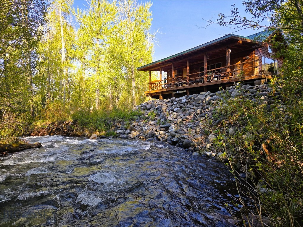 Discover your serene retreat in the heart of Montana’s Ruby Valley! This charming 924 sq ft cabin, nestled along the swift moving Wisconsin Creek near Sheridan, MT, offers a perfect blend of rustic charm and modern comfort. Situated on an expansive 18.37 acre property, this idyllic getaway boasts approximately 1/4 mile of creek frontage and surrounding mountain and valley views. From the covered deck, enjoy savoring peaceful mornings and warm summer evenings. Every window is intricately placed to maximize creek and mountain views. The property is a haven for creativity and self-sufficiency, featuring two dedicated painting studios—his and hers—perfect for artists seeking inspiration in Montana’s stunning landscape. Cultivate your green thumb in the fenced garden area with raised beds, orchard, & complemented by a greenhouse for a longer growing season. Near the orchard is an RV parking site with 110v and 220v power, and water. On the south side of Wisconsin Creek along the county road is another building site perfect for another residence, shop, etc. Surrounded by the natural beauty of the Ruby Valley, this property offers privacy, space, and endless opportunities for outdoor adventure. With the property bordering BLM lands and multiple blue ribbon fishing rivers nearby - this location is a natural playground for any avid recreationalist. Wet your line right below the cabin in the creek filled with trout. Whether you’re seeking a cozy full-time residence or a seasonal escape, this unique property delivers an unparalleled lifestyle in one of Montana’s most picturesque regions.