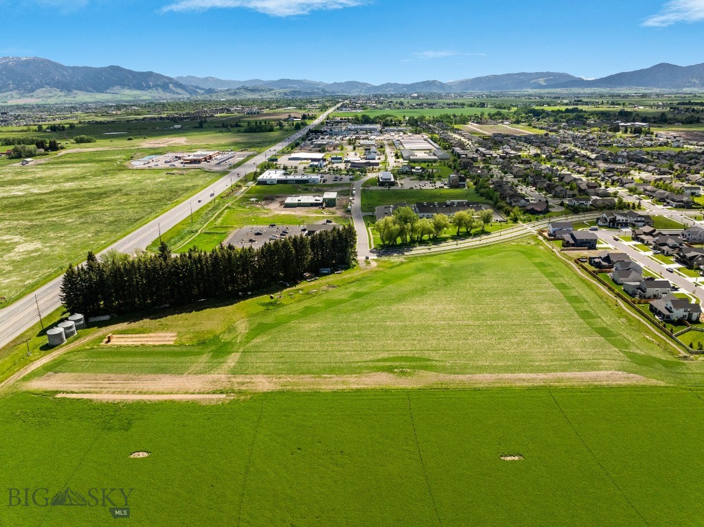 Excellent development land with Huffine frontage. This 8 acre parcel is County zoned M-I to allow for a multitude of uses. Lot is in the growing Woodland Park subdivision, and sits on the corner of Red Mountain Drive and Huffine for premier visibility. There is a farmhouse, detached garage and shed on the property that convey with the sale. There is an access easement for Haley Springs Road through the property that will create more localized visibility in addition to the heavy visibility on Huffine.