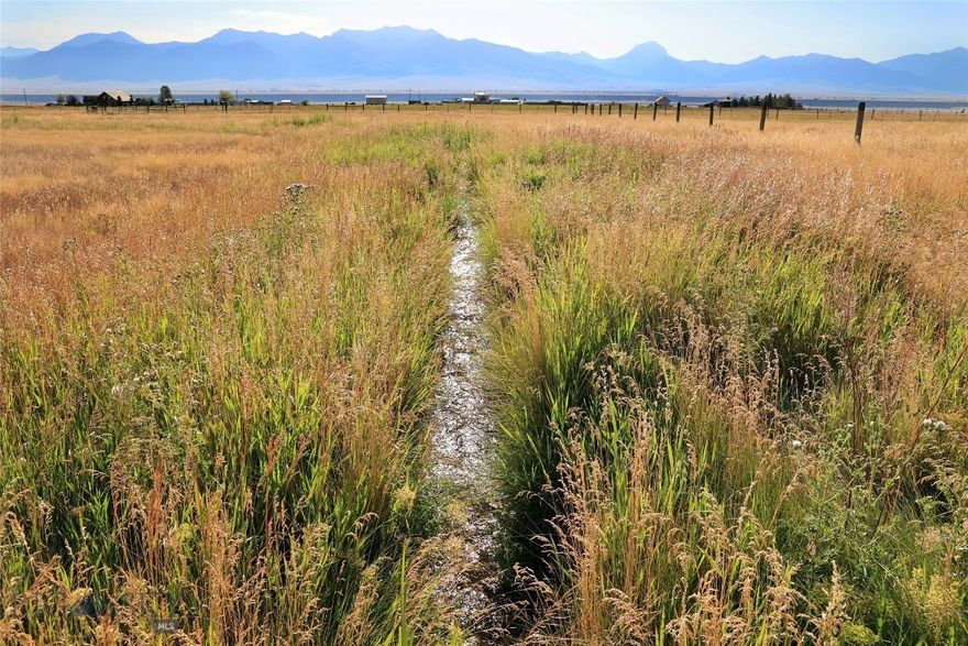 Coveted location in Shining Mountains II, situated to the east, with seasonal irrigation ditch.  These prime 6 acres check all the boxes for those seeking dramatic 360 degree views with the Madison Range, productive irrigated pastureland and easy access for your new custom home in SW Montana.  Large level lot is partially fenced making it a sweet spot for your horses with multiple build sites to take in the ever-changing landscape.  Power available in the area. Located 20 minutes from Ennis conveniences and the world-renowned Madison River, a blue-ribbon trout fishery, is just minutes away at the Varney Bridge Fishing Access.  Owners have private access to Haypress Lakes, full of trout.  Endless recreational opportunities and public lands out the back door, with Bozeman, Big Sky Resort, and Yellowstone NP each an hour drive +/-.  If you are looking for more elbow room, 18.7 total acres are available with Lots 9-11 (MLS #405843).  Photos include area views.  Create your Montana legacy today.
