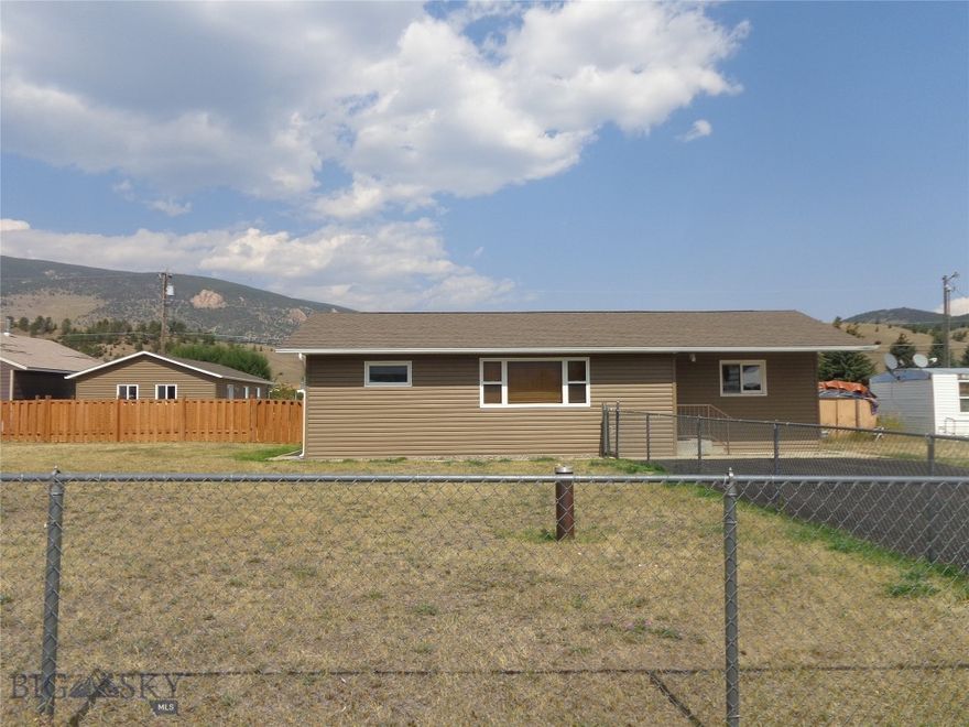 Very well maintained three-bedroom, two-bathroom home west of Anaconda with large partially fenced yard and oversized two-car detached garage.  Other features include open concept living on one floor, kitchen with oak cabinets and eating counter, upgraded electric and hot water heat, paved driveway and view of the local mountains.