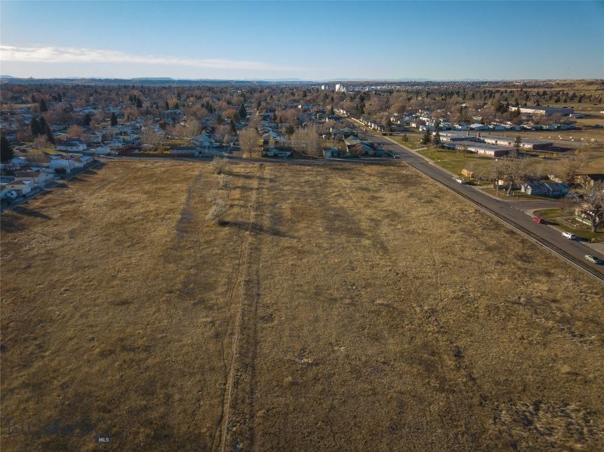 This expansive residential lot presents a rare opportunity for thoughtful development, blending the best of rural living with urban accessibility. Surrounded by city limits yet under County jurisdiction, the property offers flexibility for a variety of uses while maintaining a sense of space and freedom.
Currently zoned Suburban Residential 1 (SR-1), this property holds potential for subdivision into spacious residential lots, some of which could remain in the County and accommodate livestock or horses—an uncommon feature in such a centrally located area. Developers may also consider options such as manufactured home communities, an RV park, equine or animal boarding facility, or storage facilities, subject to zoning approvals.
The property is ideally situated for families and professionals alike, bordering Morningside Elementary School and adjacent to Heren City Park with its playground and walking paths. Located just a mile from Malmstrom Air Force Base and close to essential amenities, including Walmart, this site ensures both convenience and community appeal.
While the high clay content of the soil limits large-scale, high-density multi-family housing, it opens the door to lower-density developments tailored to the growing demand for housing in the area. With the anticipated population and job growth fueled by future infrastructure projects, this property offers a compelling opportunity for developers with vision.