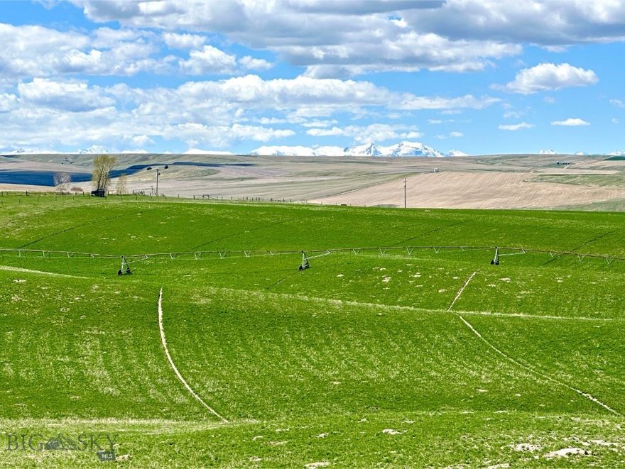 Nestled in a secluded pocket of the stunning Gallatin Valley and just 30 minutes from downtown Bozeman, the Hidden Homestead Pivot Farm offers a rare opportunity to own a premium agricultural or residential property in one of Montana’s most sought-after regions. Positioned near the charming communities of Amsterdam and Churchill, this property blends privacy, productivity, and panoramic natural beauty. Set amid gently rolling hills, the farm features over 143 irrigated acres under pivot, with transferrable water shares supplied by the Low Line Ditch, in addition to a couple shallow wells. This versatile land is ideal for both hobby and production farming or as the site of a secluded dream home. The property is situated in a quiet valley, offering peaking views of the Spanish Peaks, Bridger Mountains, Tobacco Root Mountains, and Horseshoe Hills. Natural boundaries are defined by the Low Line Canal, Camp Creek Road, and Prairie Road, creating a well-contained and easily managed landscape. Multiple prime build sites offer a range of options, from elevated locations with more robust views to tucked-away spots that ensure ultimate privacy. Whether you're envisioning a working farm or ranch, an equestrian estate, or a tranquil Montana retreat, this property provides the perfect foundation. Don't miss this rare opportunity to own a large, irrigated parcel in such a desirable area of the Gallatin Valley.