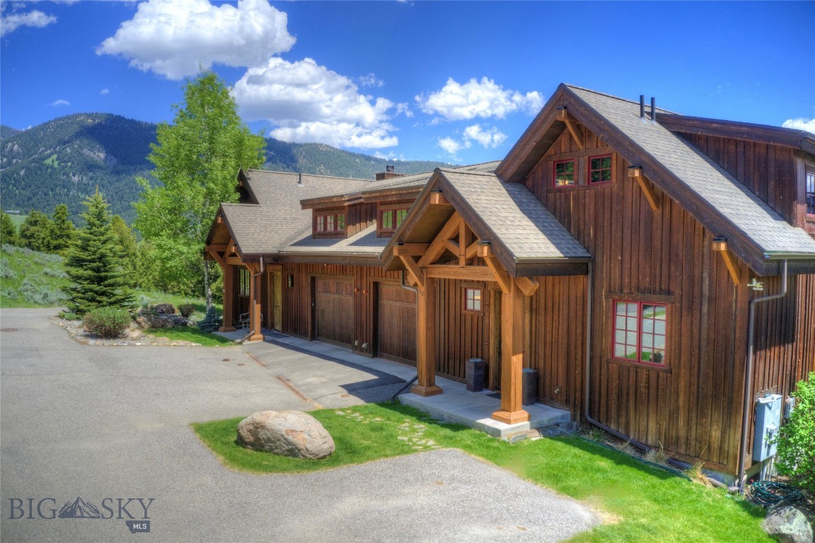 Luxury Moose Ridge Condominium in the heart of the action in Big Sky's Town Center vicinity. Great location situated on an elevated hillside with mountain views, this spacious layout features 4+/- bedrooms, 4.5 bathrooms, high end finishes, a gorgeous living room with a wood burning rock fireplace, reclaimed timbers, hand scraped wood flooring, a vaulted ceiling allowing for abundant light from the floor to ceiling windows, and a wonderful adjacent space that can be used as a additional living room space or game/pool room. The gourmet kitchen is fully equipped, has ample counter space, and a nice dining area for entertaining. The beautiful mountain views are best enjoyed from the large main deck or the lower patio while enjoying an evening in your new hot tub. Take a morning walk with your coffee and dog on the trail just out the door steps from the front door.
At +/- 3,216 sq. ft., this unit is a bit larger than comparable area properties on the market due to the loft/bunk room sleeping opportunity acting as a "4th ensuite bedroom". The property has a terrific rental history and 5-star reviews. There is a lot of room here for family, guests, and friends, and they will love the private ensuite bedrooms/bathrooms. The location is ideal and a stone's throw from the many amenities of the Town Center, and only a short drive to world-class skiing at Big Sky Resort, Lone Mountain Ranch, and blue ribbon fly fishing on the Gallatin River. Offered furnished, this property is ready to move in and enjoy all Big Sky has to offer.