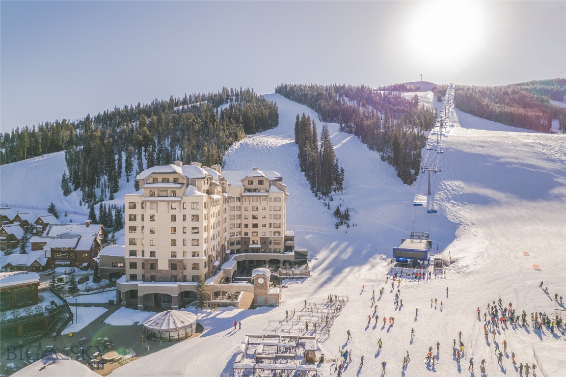 Experience the ultimate mountain lifestyle in this ski-in/ski-out condominium at the Summit Hotel, perfectly positioned at the base of Big Sky Resort. This spacious 2-bedroom, 3-bathroom residence combines comfort and convenience with direct access to world-class skiing, hiking, and year-round recreation.
Inside, you’ll find an open-concept living and dining area anchored by a cozy gas fireplace and expansive windows framing stunning mountain views. The modern kitchen is equipped with stainless steel appliances and sleek cabinetry, while two generously sized bedrooms each feature en suite bathrooms for privacy and comfort. A third full bathroom adds flexibility for guests.
Enjoy the luxury amenities of the Summit Hotel, including on-site dining, fitness, spa, pool, concierge, and valet services—paired with the ease of true slopeside living. Whether as a private mountain retreat or an investment property, this fully serviced residence offers the best of Big Sky’s alpine experience. This residence is an exceptional opportunity to own in one of Big Sky’s premier ski-in/ski-out destinations.