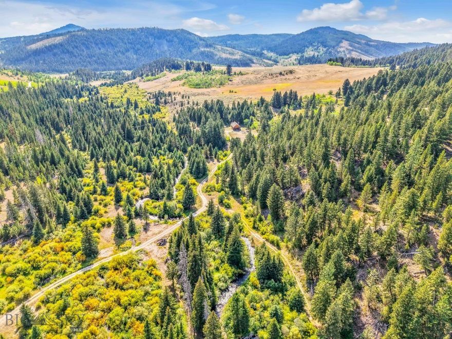 Experience the quintessential Montana lifestyle on this extraordinary 80-acre ranchette in the Little Belt mountains adjacent to 150,00 acres of U.S.Forest Service land. A rare offering, this property blends the ultimate in outdoor recreation with modern-day connectivity, creating a place where you can truly live, work, and play in Big Sky Country. Nearly half a mile of pristine Moose Creek frontage flows through the property, a clear mountain stream and tributary to Sheep Creek and the legendary Smith River. Wildlife abounds, offering unmatched opportunities for hunting, hiking, skiing, and snowmobiling right from your doorstep. At the heart of it all is a cozy log cabin, thoughtfully designed with a welcoming layout that makes gathering with family and friends effortless. Whether you’re sharing stories by the fire, hosting a weekend getaway, or simply soaking in the quiet of the mountains, this is a place where lifelong memories are made. Though wonderfully remote, access is easy via Highway 89, and the property is serviced by super-fast fiber optic internet, keeping you connected to the outside world while you’re miles away from it all. Major airports in Great Falls, Bozeman, and Billings are within reach, making this a convenient escape. This is more than a property, it’s everything Montana has to offer.