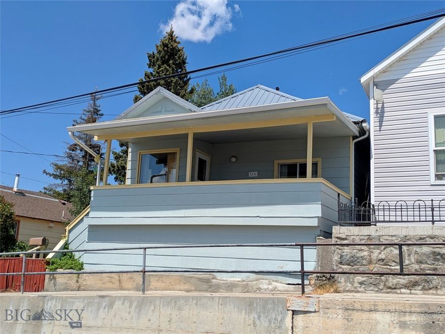 Enjoy incredible views of the Highlands, Lexington Headframe, and the city of Walkerville and Butte from this well-kept 3-bedroom, 1-bath home. Perched in a quiet neighborhood, this property offers both charm and space, with a large covered front porch perfect for relaxing and drinking your morning coffee.
The main level offers a practical layout with three comfortable bedrooms and a full bath. A cozy living area flows into the kitchen, and there's plenty of storage throughout the home. Washer/Dryer are included right off the attached 2-car garage. The garage provides additional storage or a great workspace, and the extra half-lot adds privacy, mature trees, and a fully fenced yard—ideal for pets, gardening, or outdoor gatherings.
Whether you're looking for your first home or just a peaceful place with a great view, this one has a lot to offer.