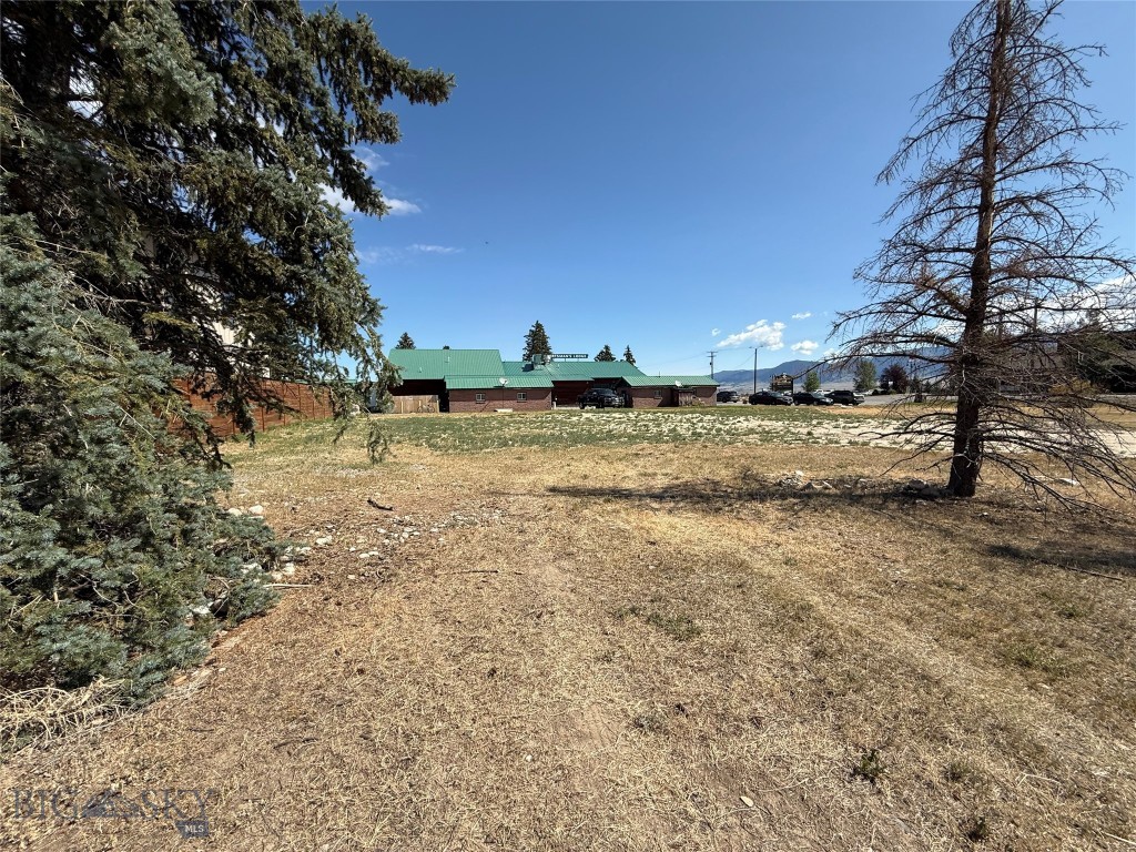Large lot adjacent to the Sportsman's Lodge, one lot off US Highway 287, just north of downtown Ennis, around the corner at Clark St. It is across the highway from the Madison Valley Medical Center and across Clark Street from the Red Bear Inn. This lot is zoned "Highway commercial" with a Conditional Use Permit allowing commercial or multi-family units. The lot has city water and sewer available, excellent traffic exposure and good side-street access. The adjoining Lot 1A (9,770 SF) to the east, is also available.