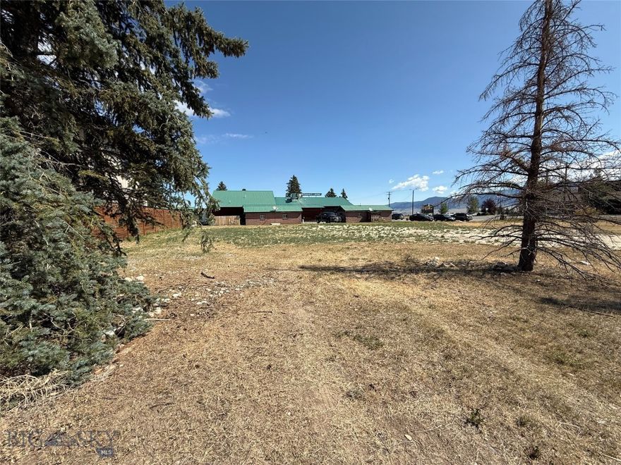 Large lot adjacent to the Sportsman's Lodge, one lot off US Highway 287, just north of downtown Ennis, around the  corner at Clark St. It is across the highway from the Madison Valley Medical Center and across Clark Street from the Red Bear Inn. This lot is zoned "Highway commercial" with a Conditional Use Permit allowing commercial or multi-family units.  The lot has city water and sewer available, excellent traffic exposure and good side-street access.  The adjoining Lot 1A (9,770 SF) to the east, is also available.