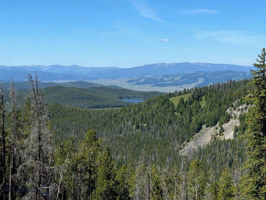 The property is located near Georgetown Lake on a gated private road; it is very private. 23.5 acres of prime Montana Property for Sale bordering the National Forest.  There’s a fantastic building site that’s already been prepared and is ready to build that cabin in the woods you’ve always dreamed of. The setting is a must see to believe. This property isn’t a small lot in those subdivisions down by Georgetown Lake, and it doesn’t have covenants or restrictions. And you’re up high where you’ve got distant views of Georgetown Lake and Echo Lake as well as Discovery Ski area, which is only a few miles away. You’ve also got views of the Anaconda Pintlar Mountains and Wilderness Area, the Bitterroot Mountains, the Sapphire Mountains, and the Flint Creek Mountain Range. This is a high Montana mountain property, yet it’s only about 4 miles to the pavement and about 7 miles from Montana’s Georgetown Lake, which has great fishing and water sports. You can hunt on your own property or take off onto all the National Forest lands right there next to you. There’s lots and lots of high mountain country to hunt, hike and enjoy. Georgetown Lake is well known, and property here is highly sought after. That’s not to mention the property borders the Beaverhead Deer Lodge National Forest. There are tens of thousands of acres right out the back door of the cabin you could build here on your very own property. You’re right out in prime elk and deer country, as well as moose and other wildlife. And with a general tag for elk and unlimited tag for mule deer bucks as well as additional cow elk tags, there is a lot of opportunity to take advantage of. That’s not to mention all the high mountain lakes the Flint Creek Mountains hold that you can drive or hike to and fish. The property has mostly steeper ground but has a good-sized leveled site at the end of the road to build your Montana log cabin overlooking the Flint Creek drainage and Georgetown and Echo Lakes, or simply camp and enjoy the great setting and the amazing views. There’s even an old log miner’s shack sitting there at the site. Stake your claim. It sounds as though visible gold was once found where the leveled building and camping site now sits. Being up at 7600 feet in elevation and almost level with Discovery Ski Area. yet it’s a short drive, and you’re back to civilization and all the amenities. It’s the best of both worlds. If you’re ready to get away and build that cabin, this is the property for you.