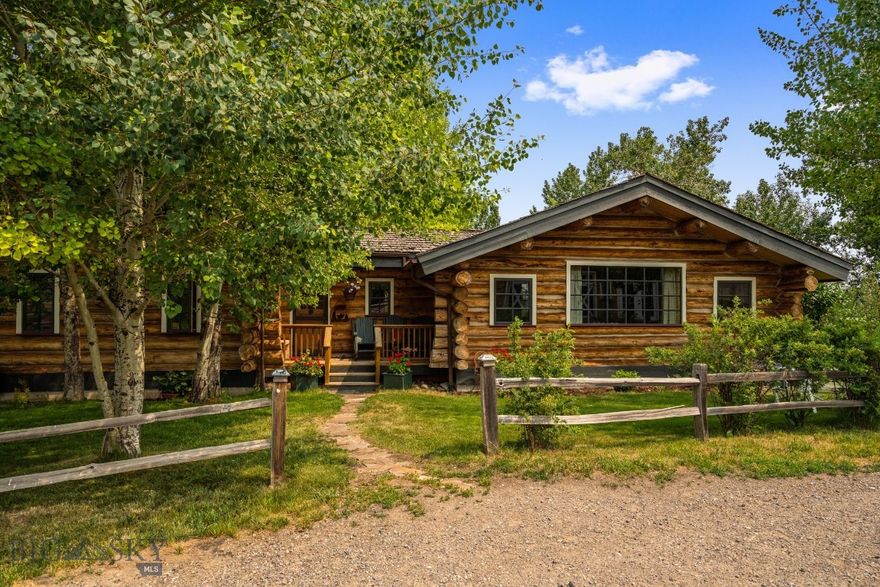 Have you dreamed of living on a property featuring a trout-filled creek, private pathways winding through wooded hillsides, and benches perfect for reading and relaxing? Want to enjoy Montana evenings by the fire pit or take in the quaking aspens and heavenly roses outside your door?  Imagine at the heart of this oasis is your private lodge, meticulously hand-crafted by renowned craftsmen known for their work on iconic log structures in Yellowstone National Park and the surrounding area. This special home offers numerous gathering areas that showcase stunning views of Spanish Peaks and Bridgers. Fireplaces in the living and dining areas create a warm, inviting atmosphere for family and friends.  The property is septic-approved for four bedrooms and includes space for a guest house. Additionally, there is a 1,024 sq. ft. heated shop for your toys, a loafing shed for your animals, and a chicken house for farm-fresh eggs. All of this is within fifteen minutes from downtown Bozeman and MSU.