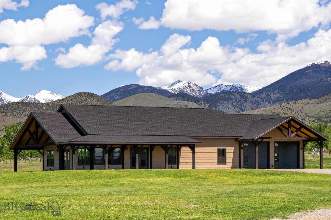 Welcome to this stunning, brand-new custom built home in the desirable Homestead Subdivision, nestled on ±2.62 acres of picturesque land. With 2,080 square feet of beautifully designed living space, this home offers the perfect blend of modern comfort and rustic charm.
Featuring an open floor plan in the main living space, this home also has three spacious bedrooms and two and a half bathrooms. The luxurious primary bedroom includes a large walk-in closet and a serene en-suite with a deep soaker tub, providing a private retreat after a long day.
The heart of the home is the large kitchen and living space, perfect for preparing meals and hosting gatherings. Vaulted ceilings with exposed beams add a sense of grandeur to the living spaces, while a natural gas fireplace adds warmth and coziness to the living room.
The home also includes a spacious 2-car garage and a covered wrap around patio, adding practicality to the luxurious living experience. This is the perfect opportunity to own a brand-new home with stunning mountain views, exceptional design, and ample space still within a short drive from the amenities of Sheridan.