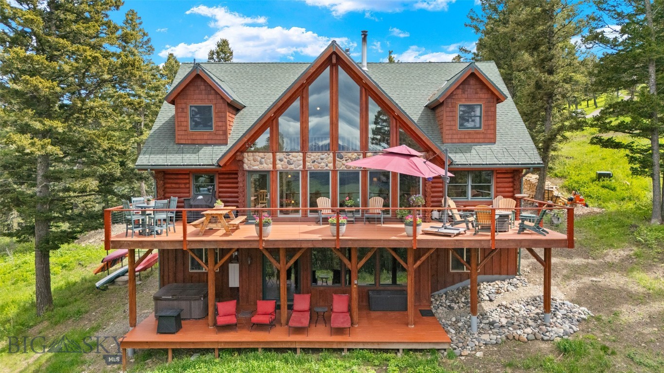 Welcome to Moose Haven, a stunning log home nestled in the serene beauty of nature. This extraordinary property offers 5 bedrooms, an office/bedroom, and 4 baths, providing flexibility for those requiring ample space. Prepare to be captivated by the incredible panoramic views of the majestic Bridger Mountains, which can be enjoyed from various vantage points, including three expansive decks. Start your mornings on the south deck, sipping a warm cup of coffee as you witness the breathtaking sunrise over the mountains. In the evenings, retreat to the upper decks or unwind in the hot tub on the lower deck, where you can marvel at the awe-inspiring sunsets that paint the sky.
This home boasts an array of features that are sure to leave you in awe. Experience the comfort and luxury of radiant heat floors, providing cozy and consistent warmth throughout the residence. The surrounding forest is teeming with abundant wildlife, allowing you to observe nature's beauty from your doorstep. Situated on a generous 10.8-acre lot, this property offers a true sense of seclusion and tranquility. The wooded surroundings provide privacy and a serene atmosphere, creating a retreat-like ambiance. Inside the home, you will find beautiful appointments and meticulous craftsmanship throughout. From the soaring ceilings to the carefully selected finishes, every detail has been thoughtfully considered to create a one-of-a-kind dream home. This is not just a house; it is a sanctuary where you can escape the hustle and bustle of everyday life and immerse yourself in the wonders of nature. Conveniently located, Moose Haven offers the perfect balance of peaceful seclusion and accessibility to amenities. Just 15 miles away, you'll find the charming and historic downtown Bozeman, where you can explore local shops, dine at exquisite restaurants, and immerse yourself in the vibrant community. For outdoor enthusiasts, the renowned Bridger Bowl ski area is a mere 18 miles from your doorstep. Spend your winters carving through fresh powder and enjoying world-class skiing and snowboarding adventures.
Whether you're seeking the tranquility of nature or the excitement of nearby attractions, Moose Haven provides the ideal location to embrace both. This remarkable log home offers breathtaking views, abundant wildlife, and a seamless blend of rustic elegance and modern comfort. Don't miss the opportunity to own this extraordinary property and experience the ultimate in mountain living.