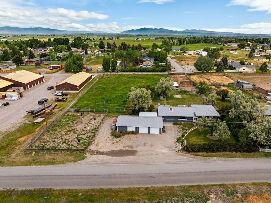 Rural living just 3 miles from downtown Dillon with irrigation! 1125 Webster Lane offers a rare combination of space, flexibility and location close to town. Situated on 2 acres, no known covenants and 2 wells (1 for residential and 1 for irrigation), this property features open land, functional outbuildings and the freedom to use the space in a variety of ways.
The 4-bedroom, 2-bathroom home provides a spacious interior with over 2,400 square feet of living space to accommodate a variety of needs. Generous windows bring in natural light, and the open living areas offer comfort and practicality. Custom wood accents add character throughout the home, while there is added warmth and efficiency from a gas insert and wood stove on the main level, and a gas stove on the lower level. 
The property acreage is thoughtfully setup and well-suited for small-scale livestock or agricultural use, with perimeter fencing, 4 pens, a tack room, arena, barn and shed. Manage the field efficiently and effectively with the opportunity to irrigate with a separately metered irrigation well and corresponding equipment! A 1,152 sqft, 3-car garage provides plenty of parking and storage with the additional attached carport. Need room to work in? One garage bay is fully insulated and heated, functioning as a turnkey workshop-ideal for tools, hobbies, storage or remote work.
The large yard features mature trees and shrubs, a garden area, back patio, perimeter fencing, horseshoe pit and wide-open views of the surrounding rural community. Properties that offer this level of flexibility, space, irrigation and proximity to Dillon are limited in todays market.