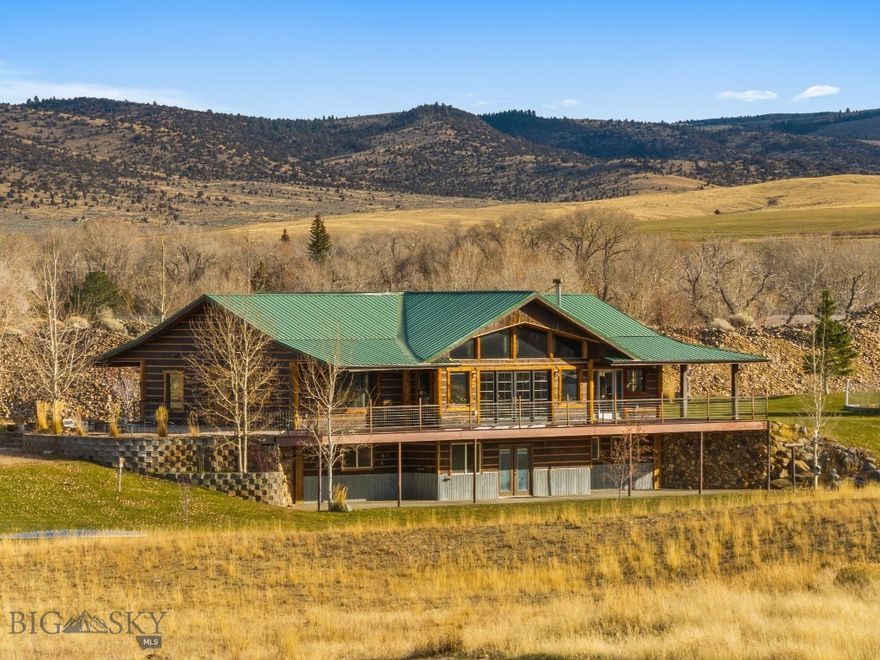 This captivating residence commands attention with its grand scale and rustic details. Expansive front windows frame breathtaking views of the Ruby mountains. Thoughtfully designed to harmonize with its surroundings, the home features nature-inspired textures and earthy tones, including corrugated tin siding paired with fir log accent. Built in 2011, this home offers open concept kitchen and living room, four bedrooms plus a bonus room easily utilized as a fifth bedroom, 3 bathrooms, spacious dining room with a bar, gym, & large laundry room. The kitchen is a chef's dream, equipped with stainless steel appliances, durable non-porous Corian countertops, and soft-close cabinets. For hobbyists or mechanics, the massive garage/shop includes a storage loft and additional living quarters. Test your green thumb in the large greenhouse. Relax next to the wood stove surrounded by cozy lodge ambiance. Unwind on the spacious front deck, take in panoramic views, and enjoy the meticulously landscaped yard with underground irrigation. This home is a true masterpiece of comfort and craftsmanship.