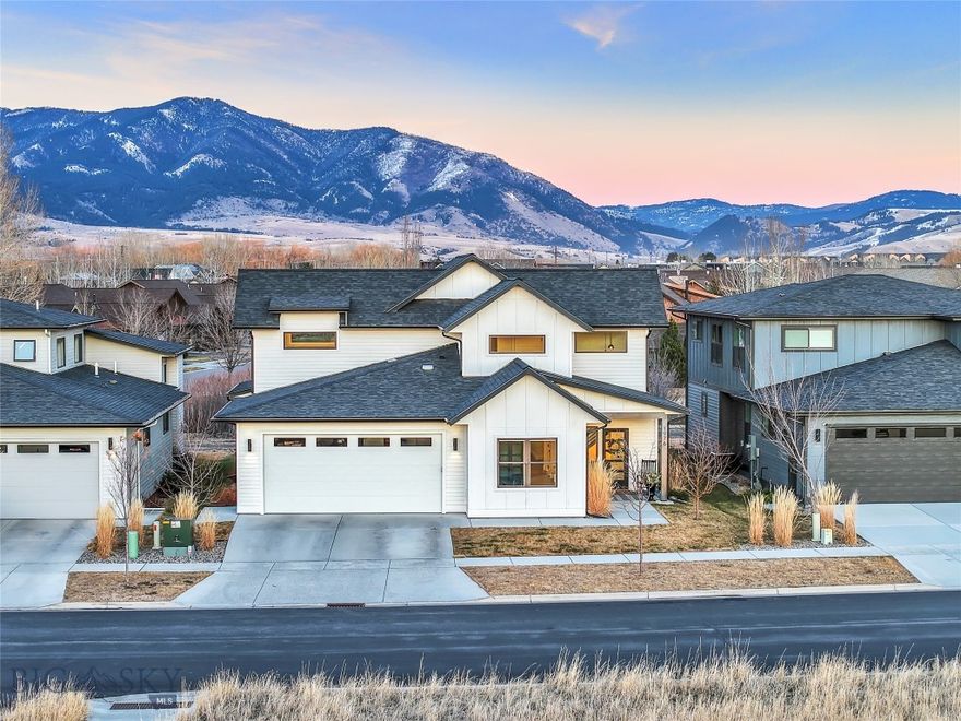 Backing to the trail system with sweeping Bridger Mountain views, this thoughtfully designed Old Mill Homes residence sits across from Gallatin Regional Park and delivers space, light, and a layout that truly lives well. Offering approximately 2,800 square feet, 4 bedrooms, and 3 full bathrooms, the home features an open-concept main level with vaulted ceilings, large windows with automated blinds, and a natural flow between the living, dining, and kitchen spaces.

The main-level primary suite overlooks open space and offers direct access to the back patio, creating an easy indoor-outdoor connection. The kitchen anchors the heart of the home with quartz countertops, abundant cabinetry, and a generous walk-in pantry with built-ins. Upstairs, you’ll find two additional bedrooms, a full guest bath, and a spacious secondary living area, plus a striking custom metal railing that ties the design together.

Known for bright interiors and excellent storage, Old Mill Homes delivers here with a clean, functional layout in a prime neighborhood location near trails, parks, and everyday conveniences.