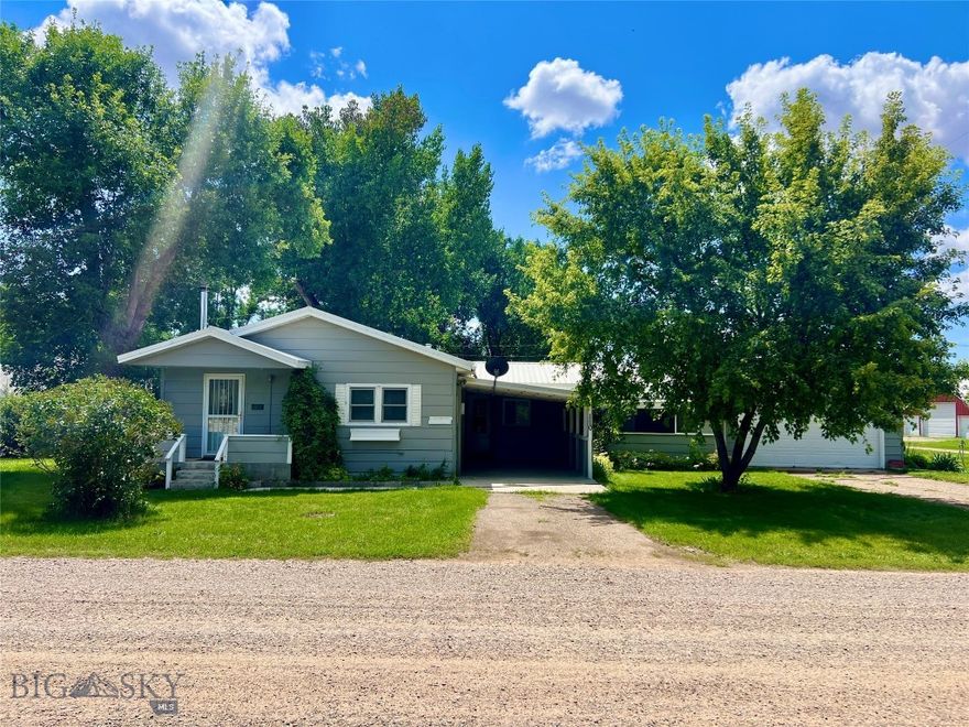 Where agriculture and outdoor recreation define the pace of life, Loma, Montana offers a historic and scenic setting to call home. Nestled in this quiet, welcoming community, this charming 3-bedroom, 2-bath single-level home sits on nearly half an acre, blending comfort with practicality. The well-maintained manufactured home includes multiple thoughtfully designed additions, all insulated for year-round energy efficiency and built on concrete slabs. A bright sunroom located off the laundry room provides flexible space—expand your kitchen, create an inspiring art studio, or simply enjoy the extra room to unwind. Step outside to a spacious yard ideal for gardening, entertaining, or soaking in the serenity of small-town Montana life. A covered area offers versatility—use it for wood or tool storage, or convert it into a functional greenhouse. The home's layout is designed for today’s evolving lifestyle. A unique third bedroom setup includes an adjoining private sleeping space or studio—perfect for siblings, a nursery with a parent suite, or a personalized workspace. In Loma, the possibilities are as creative as your lifestyle. Come experience comfort, space, and Montana charm all in one inviting package.
The attached two-car garage is heated with a large stove, and an additional carport provides extra covered parking. Inside, the home has undergone numerous updates, including new flooring, an upgraded kitchen with modern appliances, and improved PEX plumbing. Just minutes away, the Marias River offers outstanding fishing opportunities for catfish, sturgeon, northern pike, and walleye. The nearby Missouri River provides additional access for boating, kayaking, and wildlife viewing. Hunters will appreciate the surrounding habitat that supports mule deer, whitetail, upland birds, and waterfowl. The area’s rolling prairies, coulees, and river bottoms invite outdoor adventures year-round, from hiking and ATVing to shed hunting and stargazing under the big Montana sky. Access to major amenities is an 11-mile drive to Fort Benton or 52 miles to Great Falls where there is an International Airport.