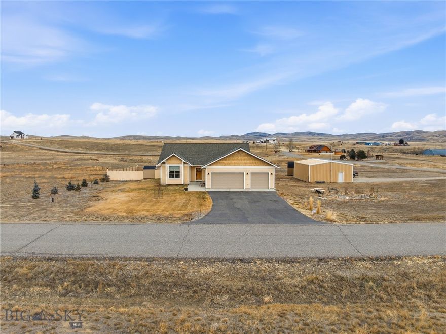 Check out this beautifully built home on two lots, totaling just over 3 acres!  This custom home boasts 4 bedrooms and 2 bathrooms, including a gorgeous primary suite with a large walk-in closet, tiled walk-in shower, and double vanity.  The large kitchen has a huge center island with granite countertops and a walk-in pantry.  The sizeable dining area has patio doors leading to a covered patio, and the spacious living area boasts an amazing floor-to-ceiling stacked stone fireplace.  The three-car garage offers space for all your vehicles and toys, and even has extra space for working.  Outside, the landscaped yard offers many trees and bushes, perennials, and even a greenhouse!  On the second lot is the large shop (30'x40'), and a dry guest cabin(14'x28') with a loft that would make an amazing art studio, she-shed, or man cave!