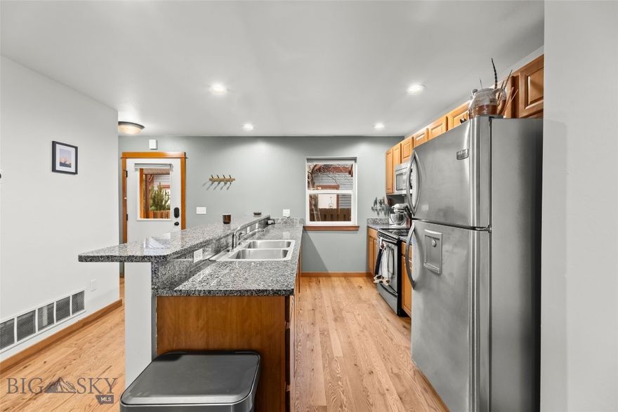 Welcome to 481 N Ferguson #C in the sought-after Valley West Subdivision. This beautiful 2 bedroom, 1.5 bathroom condo offers comfortable living in one of Bozeman’s most popular neighborhoods. Hardwood flooring throughout the main level creates a warm and timeless aesthetic, while granite countertops in the kitchen add a refined, durable touch. The main floor also features a convenient half bath - ideal for guests and everyday functionality. Upstairs, two bedrooms provide flexibility for a home office, guest space, or additional living area. The washer and dryer are conveniently located on the upper level near the bedrooms and convey with the property. Stylish updated bathroom hardware and added ceiling fans in the bedrooms enhance both comfort and design. Additional highlights include a one-car garage with a parking space in front, plus a private fenced outdoor area - perfect for enjoying summer evenings or creating your own quiet outdoor retreat. This condo offers an excellent opportunity to enjoy the convenience, community feel, and lifestyle that make this part of Bozeman so desirable.