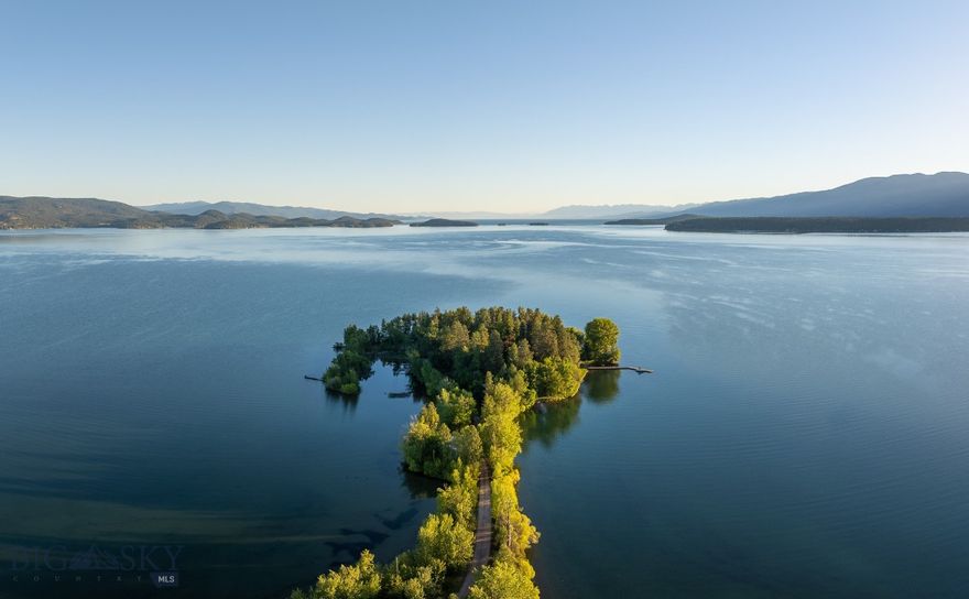 Bird Point is one of the most remarkable waterfront offerings in the West—a completely private, 7-acre peninsula at the southern tip of Flathead Lake. Surrounded by water on three sides with over 2,400 feet of protected shoreline, it offers the privacy and presence of an island—yet with full, year-round access by road or boat. The turnkey compound includes a main residence, guest house, and guest cabin, all oriented for sweeping views of the surrounding mountains and open water. Amenities include multiple docks, tennis and pickleball courts, firepits, expansive lawns, and gentle shoreline ideal for swimming—all designed for connecting with family and friends. Flathead Lake has seen rising demand from buyers seeking privacy, access, and legacy-caliber retreat properties. Bird Point stands apart and is a rare opportunity to own end-of-the-road seclusion in one of Montana’s most unique and irreplaceable waterfront settings.
