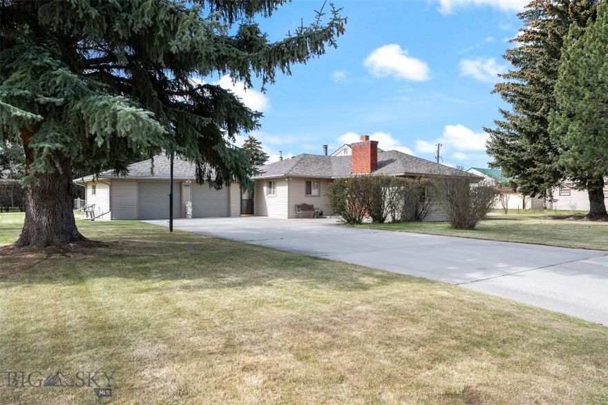 Meticulously maintained home offering exceptional space and functionality with 6 bedrooms (2 non-conforming), 2 bathrooms, and an oversized attached 2 car garage, all situated on a beautifully cared for 17,990 sq ft lot. Mature landscaping, underground sprinklers, and an extended driveway create an inviting setting with added separation from the street and ample outdoor space. Thoughtfully designed with multiple living areas and generous storage throughout, this property offers comfortable living with versatility for a variety of needs.  The main level features an open living and formal dining area with a wood burning fireplace. The kitchen includes an eat in island, large pantry, and stainless steel appliances including a refrigerator, double oven gas range, microwave, and dishwasher. A spacious main floor laundry room offers cabinetry and folding table. Additional living space includes a second main floor family room with a wood stove and patio doors leading to a private patio area. Four generously sized bedrooms on the main floor provide flexibility for guests, office space, or hobbies. The main floor bathroom features custom tile flooring and shower surround with double sinks and a large storage closet. A second full bathroom includes a custom-tiled walk in shower.  The lower level includes additional living space, utility and storage areas, hallway storage closets, and two non conforming bedrooms with large closets. The oversized attached 2 car garage includes newer garage doors and windows, built in work bench, and direct access to the home and exterior. Thoughtfully maintained inside and out, this property offers abundant space, comfort, and functionality in an established residential setting.