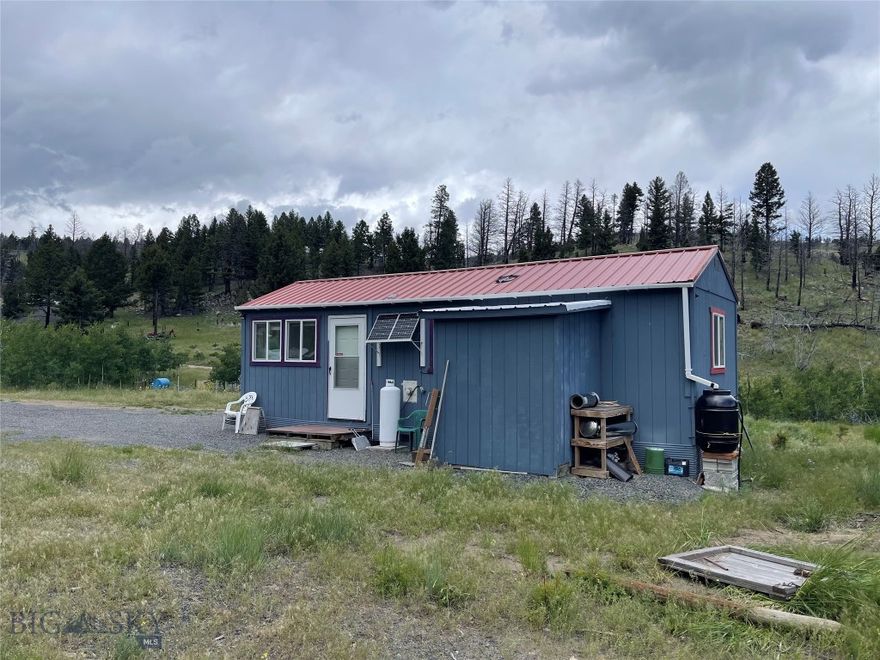 Looking for your Montana retreat??? Lush green grass, wildflowers, wildlife, and spectacular views of the Tobacco Root mountains is what this gem has to offer. Listen to the year round creek that meanders through this beautiful 18 acres of land. A 1 bed cabin has already been built but just in need of a little finish work. There is an established garden area that is irrigated by a solar powered pump. Several more building sites including one that has a concrete foundation with plumbing in place, septic has been permitted and ready to install. Multiple outbuildings, a shooting range, and some building materials are included in the sale. Property has been used as “Off Grid” but power is very close by