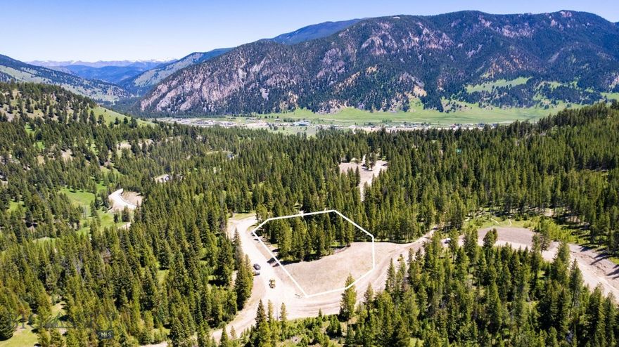 Welcome to Gallatin Foothills Phase 2, where residents will revel in spacious lots ranging from 1 to 2 acres, complemented by over 75 acres of dedicated open space. Each homesite, complete with mature trees and privacy, has been meticulously selected and designed to capture breathtaking sunrise and sunset views, alpenglow, and expansive mountain vistas, all while remaining conveniently close to town amenities. Lot 31 tucked away at the end of the neighborhood offers amazing views and gently sloping topography. Adjacent to the Terraflow biking and hiking trails, it provides a quiet location with convenient access to outdoor activities.  Neighborhood amenities include world-class Terra Flow mountain biking trails, sledding hills, and parks with open spaces perfect for hiking and cross-country skiing. At the base of the development, a trail network provides access to public lands, ideal for snowmobiling, ATV riding, and mountain biking. Fishing enthusiasts will appreciate the incredibly convenient 5-minute access to the Gallatin River.
A short drive brings you to Big Sky’s Town Center, Big Sky Resort, and an even shorter trip to Ophir Elementary School, Lone Peak High School, the Warren Miller Performing Arts Center, and countless trailheads and recreational opportunities.