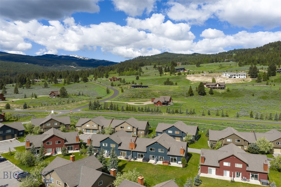 This beautifully maintained 1,850 sq. ft. two-story chalet offers the perfect mountain retreat, combining comfort, convenience, and proximity to all that Big Sky has to offer.
Featuring 3 spacious bedrooms—each with its own full bathroom and ample closet space—this home comfortably accommodates up to 8 guests. The layout is ideal for families, with a primary suite, a guest bedroom, and a well-appointed bunk room that sleeps four.
An open-concept living area with soaring cathedral ceilings and a stone fireplace invites cozy gatherings, while radiant heating in every room ensures year-round comfort. The fully equipped kitchen includes stainless steel appliances, abundant cookware, and seating for up to 10 across the dining table and breakfast bar.
Additional amenities include a one-car garage with ski storage, a separate laundry room, generous entry foyer with gear hooks, and a private hot tub that seats seven.
Located just one mile from Big Sky’s Town Center, the chalet offers easy access to shops, restaurants, markets, and seasonal events such as summer concerts and winter ice skating. Ousel Falls Trail is only a short walk away, and Big Sky Resort’s world-class skiing is just 7 miles from the property, accessible via car or free Skyline shuttle.
Summer activities include mountain biking, hiking, golf, horseback riding, fly fishing, and river rafting. Yellowstone National Park’s West Entrance is less than an hour’s scenic drive away.
Whether for a winter ski trip or a summer adventure, this turnkey chalet is the perfect basecamp for enjoying Big Sky year-round.
