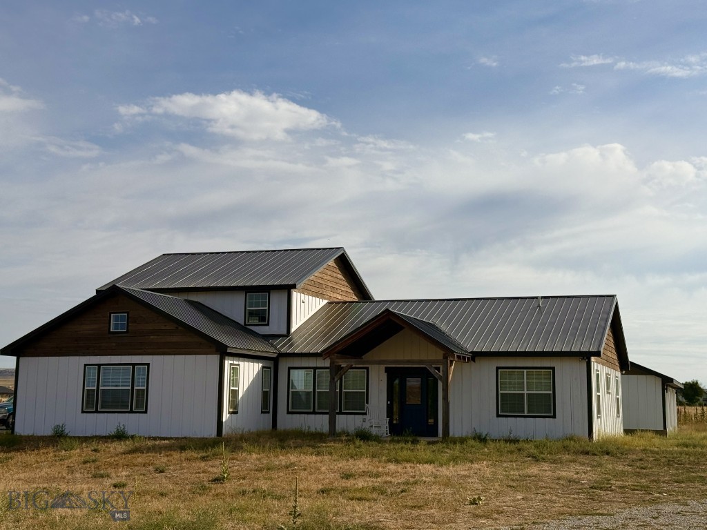 Check out this newly built custom home with stunning views of the Crazy Mountains! The expansive home boasts clean lines and a striking facade, blending traditional farmhouse elements with sleek modern finishes. Upon entering, you are greeted by an open-concept floor plan bathed in natural light, courtesy of oversized windows and soaring ceilings. With 6 bedrooms and 4 full bathrooms this home has plenty of room for your family and your hobbies, office space etc. The kitchen boasts a sleek modern design and lots of space for entertaining and hosting. The primary suite is a serene retreat with vaulted ceilings, a spa-like en suite bathroom, and a generous closet. Additional bedrooms are generously sized, each offering their own unique touches and ample storage. The home also includes a versatile home office. The oversized garage has plenty of space for your cars and your toys or workshop! With quality finishes throughout, this home is a must see! This custom modern farmhouse has been thoughtfully designed to create a harmonious blend of comfort, elegance, and contemporary living.