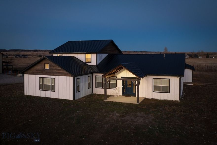 Check out this newly built custom home with stunning views of the Crazy Mountains! The expansive home boasts clean lines and a striking facade, blending traditional farmhouse elements with sleek modern finishes. Upon entering, you are greeted by an open-concept floor plan bathed in natural light, courtesy of oversized windows and soaring ceilings. With 6 bedrooms and 4 full bathrooms this home has plenty of room for your family and your hobbies, office space etc. The kitchen boasts a sleek modern design and lots of space for entertaining and hosting. The primary suite is a serene retreat with vaulted ceilings, a spa-like en suite bathroom, and a generous closet. Additional bedrooms are generously sized, each offering their own unique touches and ample storage. The home also includes a versatile home office. The oversized garage has plenty of space for your cars and your toys or workshop! With quality finishes throughout, this home is a must see! This custom modern farmhouse has been thoughtfully designed to create a harmonious blend of comfort, elegance, and contemporary living.