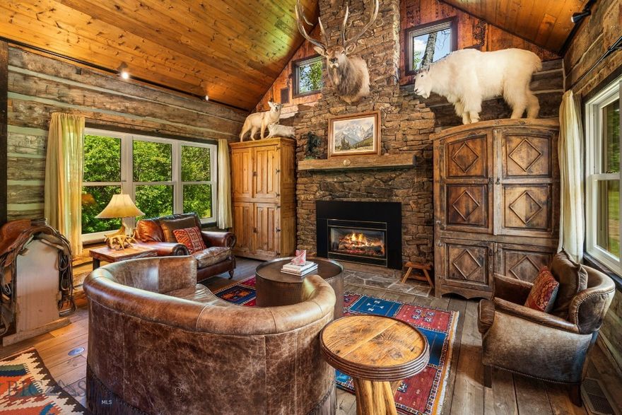 Welcome to North Ridge Ranch, where elevated living meets untamed Montana beauty, at this extraordinary legacy compound offering a rare fusion of refined design, complete privacy, and direct access to endless adventure. Set in an irreplaceable location with expansive views and quick access to National Forest land, this one-of-a-kind retreat is designed to be both a luxurious haven and a basecamp for exploring the wild. Residences on site include a 2-bedroom, 2-bathroom hand hewn cabin with a fully equipped kitchen, cozy fireplace, and private deck. A neighboring studio-style 1-bedroom, 1-bathroom cabin has been recently expanded and remodeled by the renowned Dovetail Construction, to include a stunning full bathroom, surround sound speakers, and cozy radiant floor heating.  Another 1-bedroom, 1-bathroom guest cabin connects via the expansive trail system, and makes the ideal retreat for visiting guests, or a quiet hobby area. Ideal for hosting and gathering, the property includes multiple separate guest cabins, a hot tub cabin, and an infrared sauna building, all connected by beautifully lit pathways. A large detached garage with huge loft space and its own bathroom provides ample storage or makes the perfect hobby workshop. Enjoy an additional shop for endless equipment and toy storage. Outdoor living takes center stage here, from the oversized fire pit with panoramic Bridger Mountain views to the miles of private trails that wind through varied ecosystems, trees, and wildlife-rich terrain. A true adventure-luxury lifestyle awaits—hike, backcountry ski, or explore directly from the property, with private neighborhood-only access to a trail leading into National Forest and Wheeler Mountain. The property feels expansive and wild, yet is situated just 20 minutes from bustling Downtown Bozeman. Whether you're seeking a private family compound, a multi-generational retreat, or a Montana legacy to pass down for years to come, this is a once-in-a-lifetime opportunity to own a secluded sanctuary where luxury and wilderness meet.