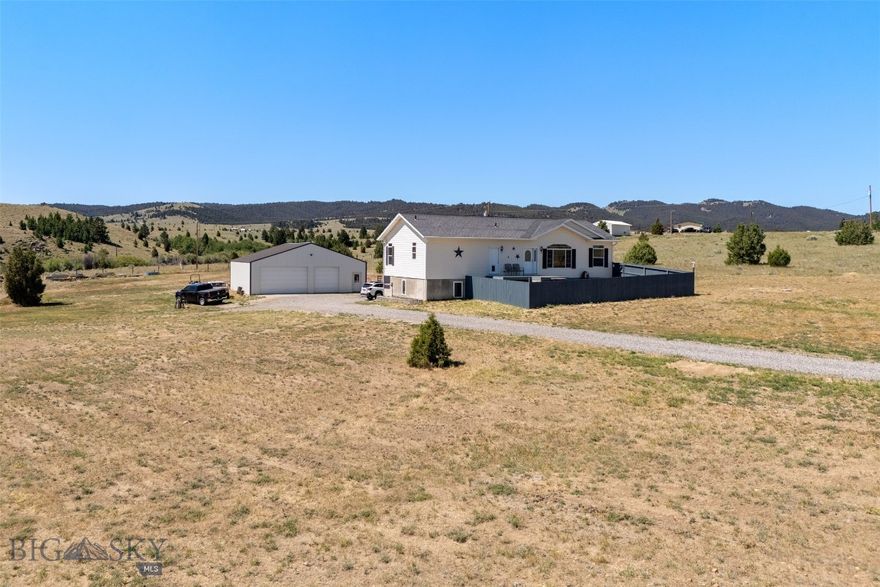 Spacious country home with luxurious updates & 1,600 Sq Ft Shop! Yes, please! Welcome to your dream home in the country! This beautifully updated 5-bedroom, 3-bathroom home offers over 3,100 square feet of comfortable living space on 2.3 private acres, with paved, well-maintained roads right to the driveway. Step inside to discover a newly remodeled kitchen featuring custom cabinetry and gleaming granite countertops, perfect for cooking and entertaining. The main level offers new rustic rough-cut hardwood flooring in the spacious living room, three generously sized bedrooms (including a true master suite), and the convenience of main-level laundry. Downstairs, the walkout basement is filled with natural light and includes two additional large bedrooms, a full bath, and a cozy wet bar—ideal for entertaining or maybe a conversion for multi-generational living. Enjoy outdoor living at its finest with a large back deck and a relaxing hot tub, or unwind on the brand-new front deck, complete with a privacy fence for pets and/or little ones. And don’t miss the ultimate bonus—a 1,600 square foot shop with an RV dump (by the septic system) and full hookups behind the shop. Whether you're a hobbyist, need space for your toys, or want a functional workspace, this shop is a rare and valuable amenity. Maybe the best part of this country property is the freedom that comes with no covenants! Looking to have horses, chickens, goats, or the whole dang farm? Bring them! If you’re looking for the perfect mix of space, privacy, luxury, and functionality, this is the one. Schedule your private showing today and experience everything this incredible property has to offer!