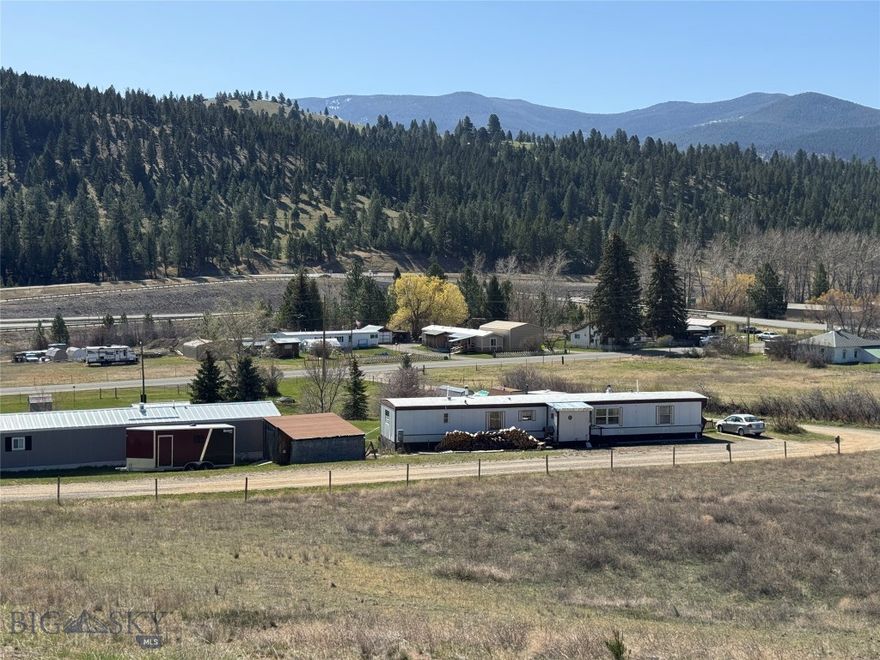 Experience the best of small-town Montana living with no covenants and a well-maintained 3-bedroom, 2-bathroom mobile home situated in the heart of Jefferson City. Spanning 0.357 acres across two full city lots, this property offers a rare combination of space and accessibility in a tranquil, rural setting. The home features a functional layout and the comforting warmth of a wood stove. The views from the living room or dining room table are refreshing. Outside, the oversized triple lot provides plenty of room for gardening, a potential shop, or simply enjoying the expansive views of the Elkhorn mountains.