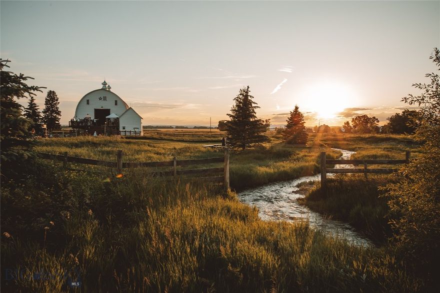 The unique Star M estate is set on 33 acres and offers breathtaking views of the Bridger Mountains and Ross Peak, with Bostwick Creek flowing through the property seasonally. Located just 8 miles from Bozeman and 10 minutes from BZN/Yellowstone International Airport, it provides the perfect balance of rural tranquility and convenience to all that Bozeman and the Gallatin Valley have to offer. The property features multiple residences, each blending comfort with Montana elegance. The main guest house (2022, 1,788± sqft) blends timeless rustic character with refined, high-end finishes. Its open-concept layout flows from a well-appointed kitchen into dining and living areas anchored by a wood-burning stove, with expansive windows framing incredible views. Two bedrooms and two baths are on the main level, with a non-egress bedroom, office, and utility space below. The renovated farmhouse blends original charm with modern updates, including refinished hardwood floors, and an updated kitchen. Offering 4 bedrooms and 2 baths across two levels with a basement, the layout provides generous spaces and comfortable living. A newly completed (2024) one-bedroom, one-bath guest cabin (650± sqft) is designed with reclaimed lumber and modern finishes, and offers ideal guest accommodations or a turnkey VRBO/Airbnb opportunity. Breathtaking views are captured from every direction.

The landmark barn is a masterpiece of rustic charm and historic significance. Thoughtfully designed lighting and a new propane fire-pit make it an exceptional space for gatherings, personal use, or events. Currently, the space serves as a seasonal wedding venue. For agricultural or equestrian use, the property offers a corral area, small smokehouse, and two squeeze chutes. Additional amenities include a heated, insulated 40x60 shop (2021), a renovated shed office, and RV pad with full hookups. With all-new 800-amp electrical service, four wells, and three new septic systems—two allowing additional structures—the property is primed for expansion or development.

Two 10-acre pastures to the north and south of the main homestead remain undeveloped and leased for farming, but offer opportunity for subdivision. This extraordinary Montana property offers a blend of history, luxury, and limitless possibilities. Whether envisioned as a private retreat, multigenerational property, wedding venue or legacy holding, the Star M estate is truly one of a kind. Schedule your private tour today.