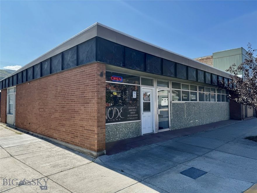 Entrepenures and Investors! Discover exceptional Main Street visibility and potential with this 4,150± sq. ft. commercial building ideally located on bustling East Park Avenue in the heart of Anaconda Montana's business district. Built in 1960 and situated on a 7,013± sq. ft. lot, this property offers versatile space suited for retail, office, or mixed commercial use. Large display windows provide excellent street exposure and natural light, creating an inviting presence for customers and clients alike. The building’s phenomenal corner lot location ensures steady traffic and easy accessibility, just steps from downtown Anaconda amenities and other thriving local businesses. The current use, and business Anode Design's is also for sale. Anode is a profitable clothing, apparel, and embroidery company that creates and sells custom clothing items, including options like t-shirts, hats, and other promotional apparel. The company has oodles of potential, and vast room to grow.  The large building, coupled with the companies growth capabilities, make this property and business very appealing to all potential buyers. The large lot offers ample space for future expansion, and operational growth, as business needs evolve. Whether you’re an investor seeking a solid and proven income property, and / or a business owner ready to establish a presence in one of Montana’s most historic towns, this property presents a unique opportunity. Please contact me to schedule a showing.