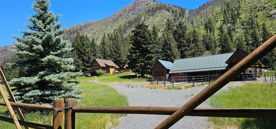 South Boulder Riverfront – Peaceful Mountain Getaway with Horse Facility in Mammoth, Montana

Bring your horses and settle into this peaceful retreat tucked away in Montana’s stunning Tobacco Root Mountains. With South Boulder River frontage, this property is the ideal spot for fishing, hunting, outdoor adventures, or simply soaking in the beauty of nature.
Step out onto the spacious trex deck and take in panoramic mountain views and watch the  wildlife. Inside, the cozy living room is great for relaxing, spending time with friends, or just enjoying the view. The convenient kitchen makes it easy to cook and gather, the dining area opens onto the deck, perfect for BBQs and entertaining.
The home features three bedrooms, one of which is a loft-style bedroom also perfect for a home office, reading nook, or creative studio.  The property is ready to go with a barn, corrals, a round pen, and plenty of room to ride. The barn also includes a shop area and space to store your horse trailer, tractor, or other gear.
Thousands of acres of public land nearby, with scenic trails that wind through wildflower-filled meadows, lead to alpine lakes, and offer sweeping views of the Tobacco Roots.
Green house to get an early start on planting. 
Best of all, the property comes fully furnished—move-in ready so you can start living your Montana dream from day one.
Located in the quiet, unincorporated community of Mammoth, just 65 miles from Bozeman and 50 miles from Butte, this is a must-see mountain escape.