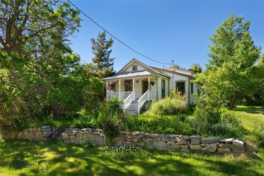 Experience the charm & elegance of the past with this exquisitely renovated vintage home, known historically as the Samuel Russell House, located on 2 city lots in the heart of VC. This shotgun-style Victorian-era cottage remains true to the architectural vernacular of its period, lovingly restored to preserve its historical integrity while incorporating modern comforts. As part of the Historic Landmark district, this home is a testament to VC's rich heritage. Originally constructed in 1900, it beautifully showcases handcrafted woodwork, authentic fixtures, & carefully selected finishes that honor its era. A historical plaque explaining the home's history from the Montana Historical Society has been placed in front. This home has undergone a complete overhaul to ensure modern comfort while preserving its vintage charm. Renovations include a new roof, new wiring & plumbing, refinished fir flooring, & new cedar siding. Every detail has been meticulously restored to maintain the authentic feel. The home features an elegant, old-fashioned front porch with a picturesque view and soothing sounds of "Daylight Creek" across the road. The spacious living room boasts a vaulted, beamed ceiling, a gorgeous, antique, stained-glass window, & a gas "wood stove." There is a side-entrance mudroom, & the kitchen includes a utility room, pantry/larder, & a root cellar believed to be part of the original dwelling. The glassed-in sunroom, complete with a wood stove & indoor planter, provides a cozy retreat for all seasons. The 2nd floor features a bedroom & full bath, plus access to a large storage attic. The property includes 2 functional outbuildings, both fully insulated & wired for electricity - good for workshops, overflow guests or storage.  Situated on 2 city lots, the property boasts original stone retaining walls with plant beds of perennials, bulbs & crab apples; hedged borders surrounded by lawn areas & mature trees. Just 1 block off from the village, this home offers convenient access to the historic downtown, including museums, shops, restaurants, and seasonal events that celebrate the town’s heritage. The owners have lovingly completed the renovation, adding details that have transformed this project into a unique & character-full residence. This is a rare opportunity to own a piece of Montana’s history. Whether you’re seeking a full-time residence, a vacation retreat, or a historical investment, this vintage home in Virginia City promises to enchant and inspire.