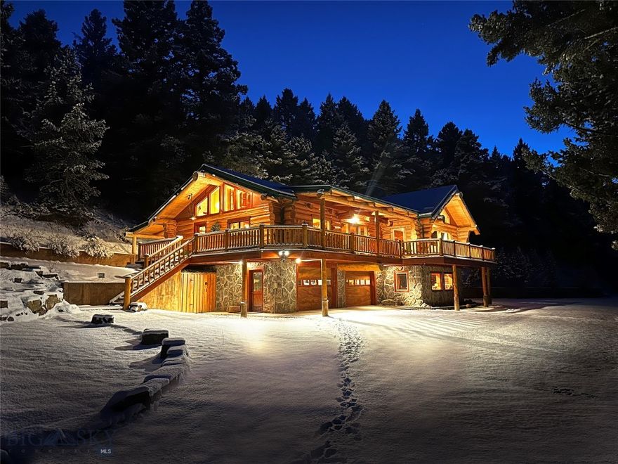 Welcome to the Cozy Alpine Chalet, a passionately handcrafted log home and legacy retreat, thoughtfully positioned on nearly 7 pristine private acres of alpine forest. Just 11 miles from both Bozeman and Livingston, and only 25 miles from Bozeman Yellowstone International Airport, the property offers effortless access to Montana’s finest dining, shopping, and outdoor adventure—yet feels like your own secluded mountain top forest escape, worlds away from it all. The main home has been extensively renovated between 2022 and 2025 with over $1 million in thoughtful upgrades including a full rebuild of mechanical systems, a smart home setup, professional interior styling, and high-end finishes throughout. Artisan log construction, natural wood and stone interiors, and over 30 Andersen windows bring in forest and mountain views from nearly every room, while six fireplaces create cozy gathering spaces indoors and out.

This mountain retreat includes a chef’s kitchen with a full KitchenAid stainless steel suite, two laundry areas, and rich character in every detail. Tucked further into the trees, the Honeymoon Treehouse Villa is a newly built architectural jewel, elevated 15 feet above the forest floor. Built to Passive House / High-Performance standards, it features quadruple-pane glazing, premium insulation, and a future cantilevered hot tub deck, all framed by a soaring roofline designed for both elegance and energy efficiency. With all utilities installed and the interior ready for your finishing touch, this secondary structure offers limitless potential: a luxury rental, a serene guesthouse, or your personal creative retreat.
This is a truly turn-key offering, with all furnishings, curated décor, bedding, chef’s cookware, and antiques included. Smart home features like Yale Wi-Fi locks, remote lighting and climate control, iPad/voice automation, and Starlink satellite internet ensure convenience and connectivity, even in this private setting.

Whether you dream of taking over a luxury short term rental business (currently commanding up to $1300/night in the high season), creating a soulful family compound, or stewarding a rare legacy property for future generations…The Cozy Alpine Chalet awaits. With unmatched craftsmanship, immersive natural beauty, and an incredible location at the gateway to America’s first national park, this is truly Montana living at its finest.
