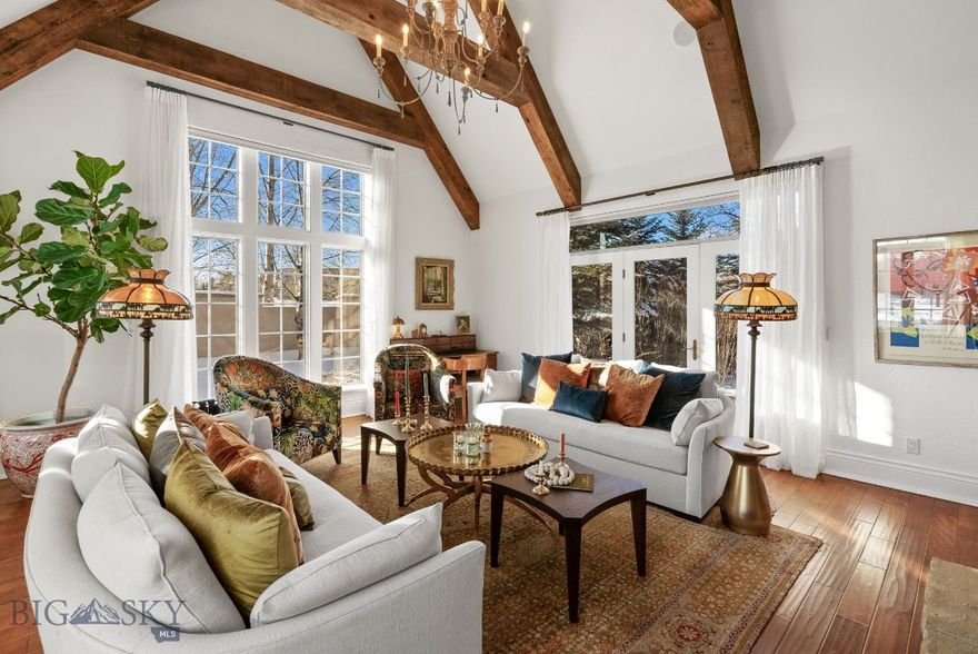 Welcome to one of Bozeman’s most inviting, luxury residences in the coveted Riverglen community. This beautifully maintained home offers warm, elevated finishes on a park-like setting that comes alive in the summer with mature aspens and vibrant landscaping. Set against 26.4 acres of public land and steps to the East Gallatin River, step inside your private entrance to a thoughtfully designed layout that lives like a single-family home. The main level features a grand living room with vaulted ceilings, hardwood floors, and a cozy gas fireplace, all framed by large windows that bring in natural light and views of the surrounding trees. The adjoining kitchen and dining area are ideal for both everyday living and entertaining, offering generous counter space, high-end stainless appliances, and seamless access to the patio for easy indoor–outdoor enjoyment. The main-level primary suite provides a spacious retreat with a walk-in closet, beautifully updated en-suite bathroom, and ample natural light. A laundry room, half bath, and direct entry to the three-car garage complete the main level. Upstairs, you will find two spacious bedrooms, a full bath, an airy loft with its own fireplace, plus an additional flex room perfect for a gym, hobby room, or home office. Thoughtful updates throughout the years include new HVAC, new roof, additional landscaping, updated tile and bathrooms, light fixtures, and closet buildouts, providing both style and function. The stone exterior, covered porch, and landscaped yard create a peaceful, established setting. The Riverglen community also enjoys sprawling dedicated open space and direct access to the East Gallatin River. Located just 8 minutes from the airport, and less than 10 minutes from bustling Downtown Bozeman, this home combines comfort, privacy, and exceptional convenience in one of North Bozeman’s most desirable areas.